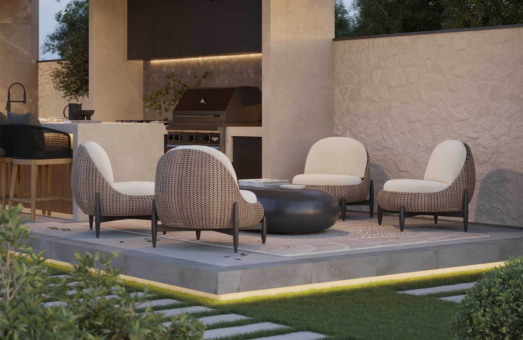 Covered outdoor seating area with cushioned chairs and woven bases on a raised patio, emphasizing comfort-focused materials that resist weather while maintaining usability