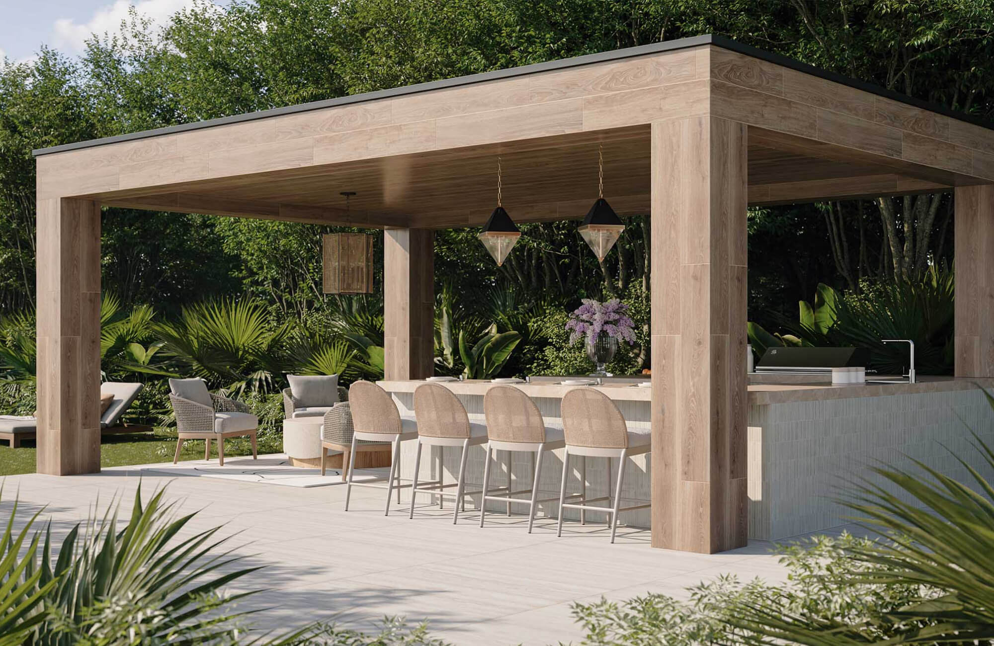 Outdoor kitchen and bar area with counter stools and wood structure under a canopy, illustrating materials chosen for durability in both direct sun and sheltered outdoor environments