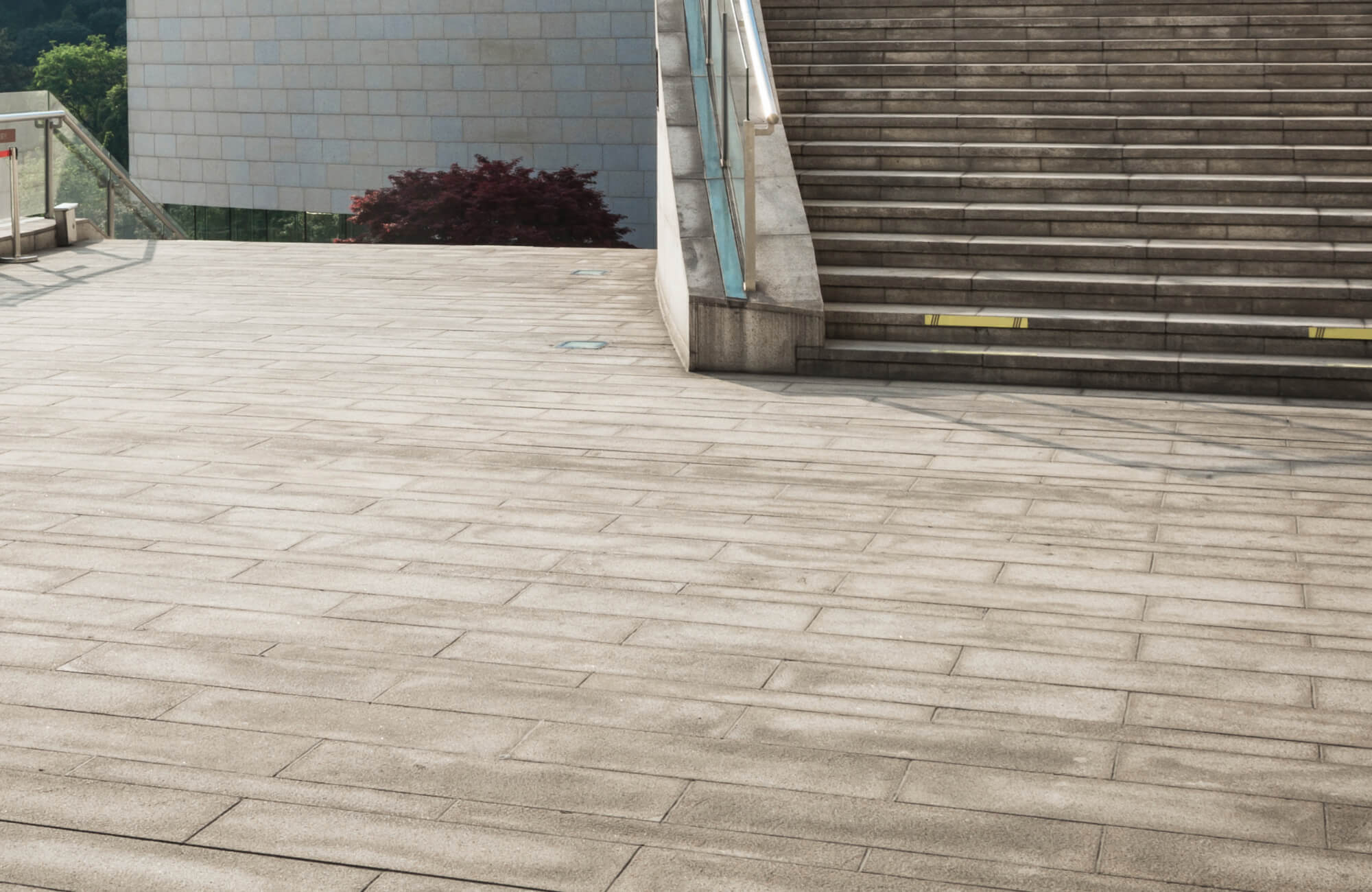 null Modern public plaza featuring large-format concrete paver outdoor flooring, delivering a clean, slip-resistant surface that complements the architectural steps and minimalist urban design.