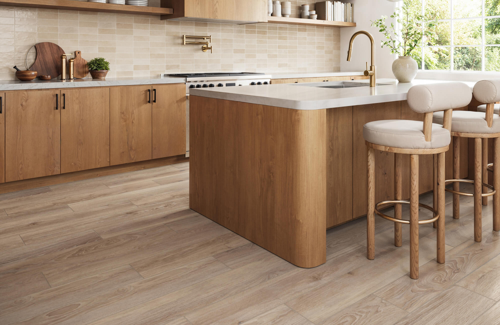 null Chevron-patterned light wood look tiles bring warmth and elegance to a sunlit entryway with black French doors.