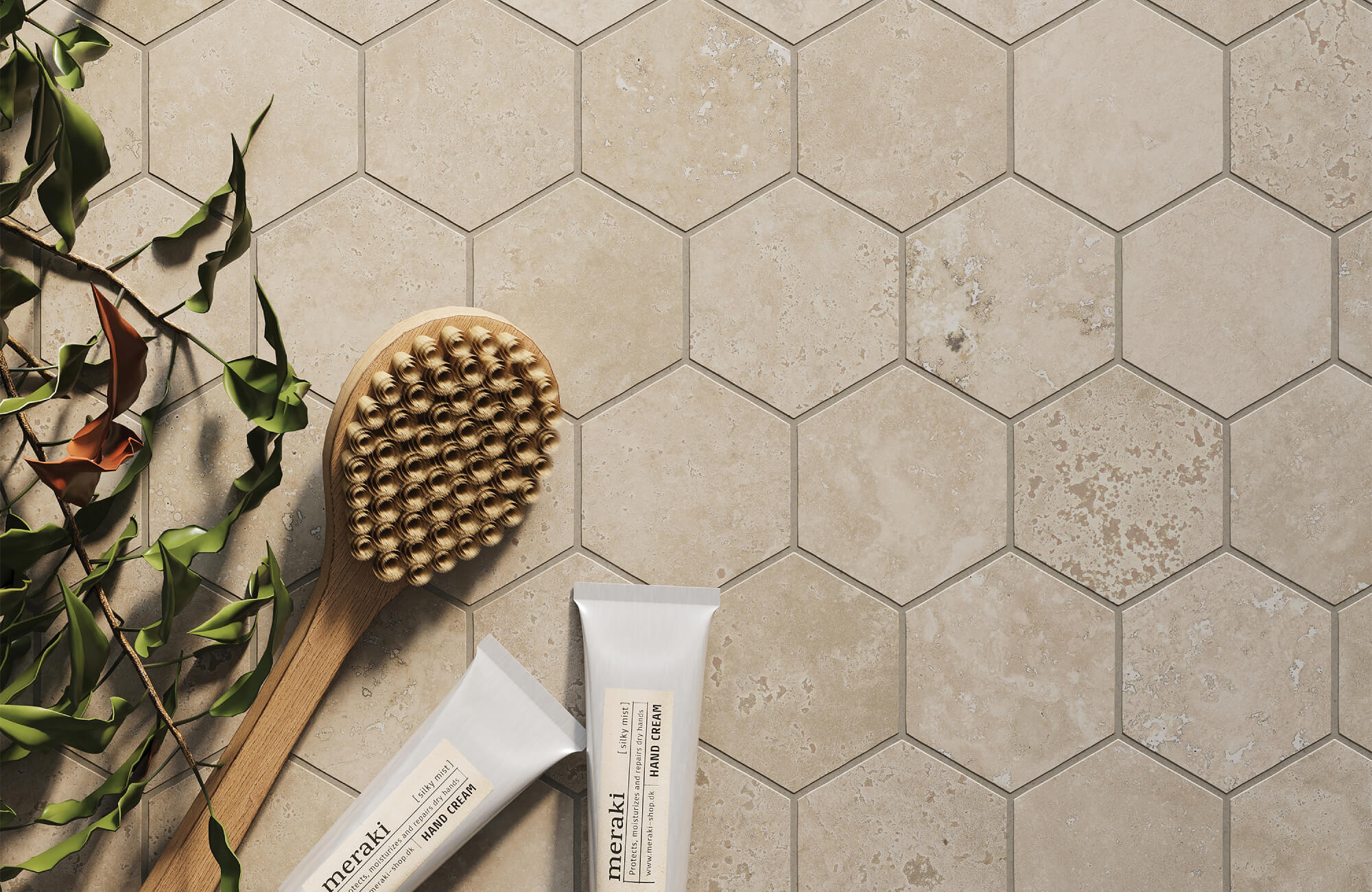 A close-up of beige hexagon tiles with light variation, paired with a wood brush and white containers for an easy, spa-like feel.