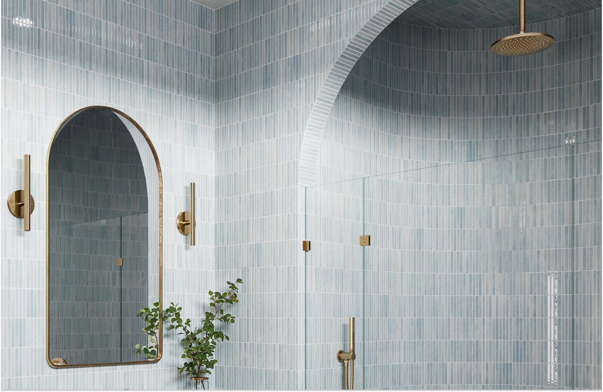 Light blue vertical shower tiles with a soft, clean look, paired with gold fixtures and an arched detail for a calm, airy space.