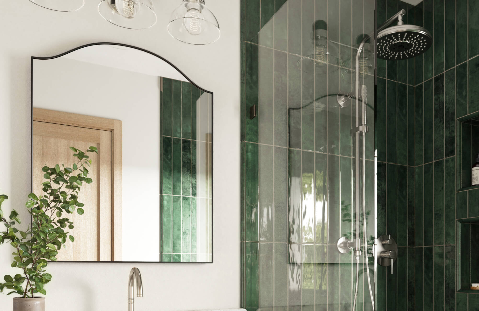 Bathroom with wavy-edged mirror, glossy green vertical tile shower, frameless glass door, brushed nickel fixtures, and potted greenery on the counter