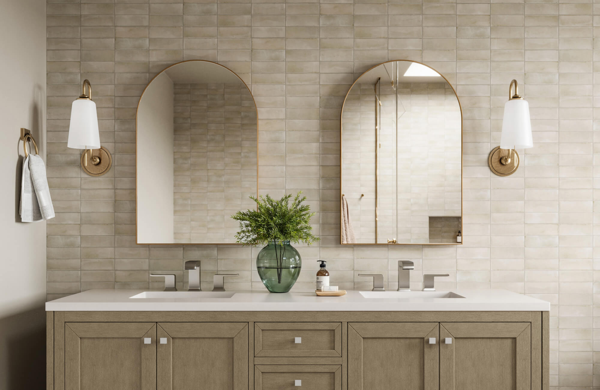 Stylish bathroom mirror pair with arched gold frames enhances a double vanity of warm wood tones, accented by wall sconces and a green glass vase for a refined, modern look.