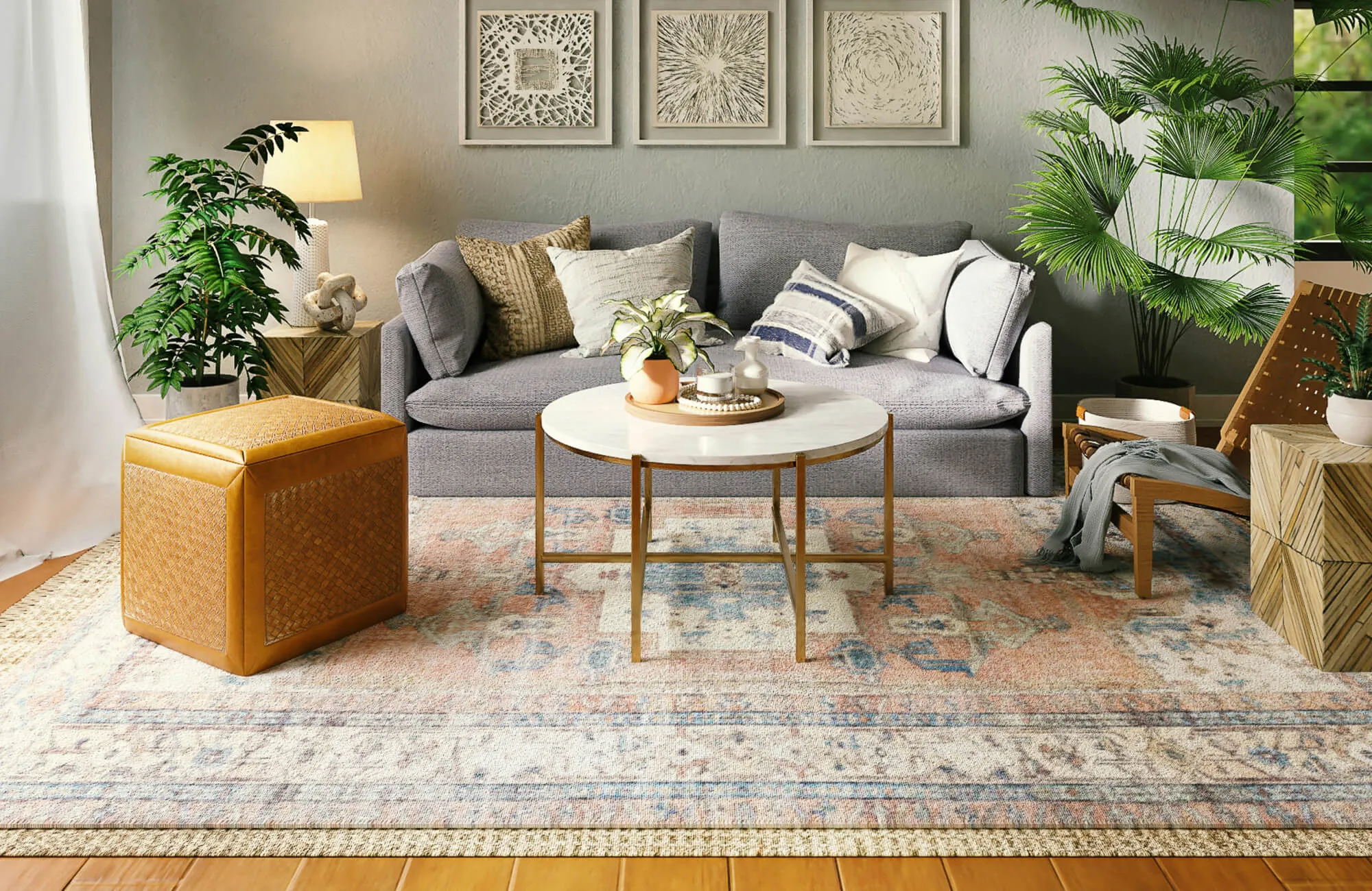 Cozy living room with light wood-look plank flooring, a patterned area rug, gray sofa, layered textiles, and lush greenery.