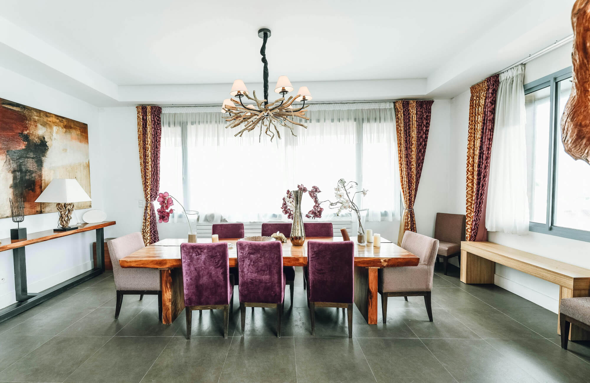 null Rustic branch-style chandelier unifying a dining room with natural texture and grounding energy.