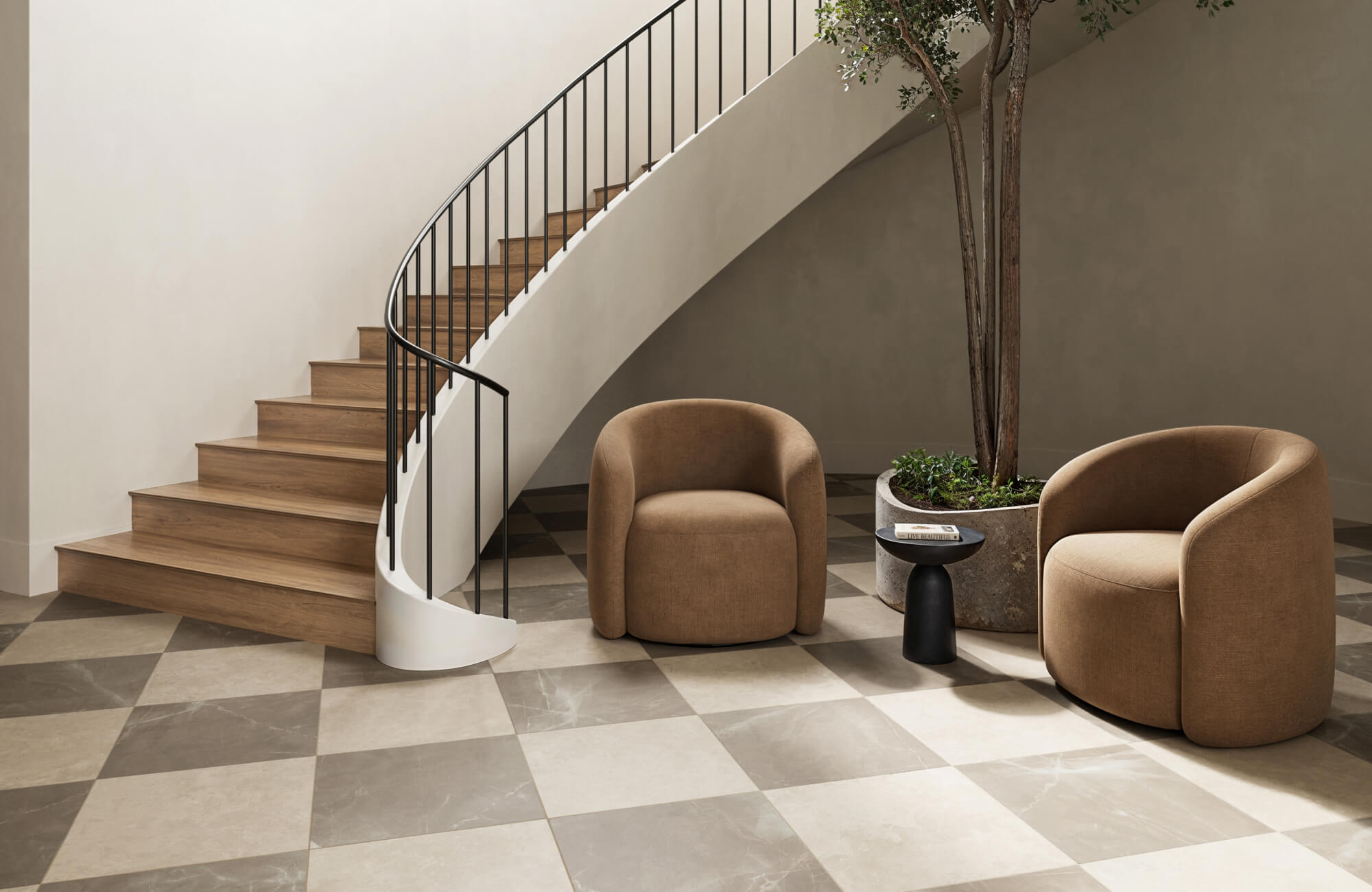 null Warm taupe and cream marble-look tiles in a checkerboard layout, grounding a serene space with curved chairs and a sweeping staircase.