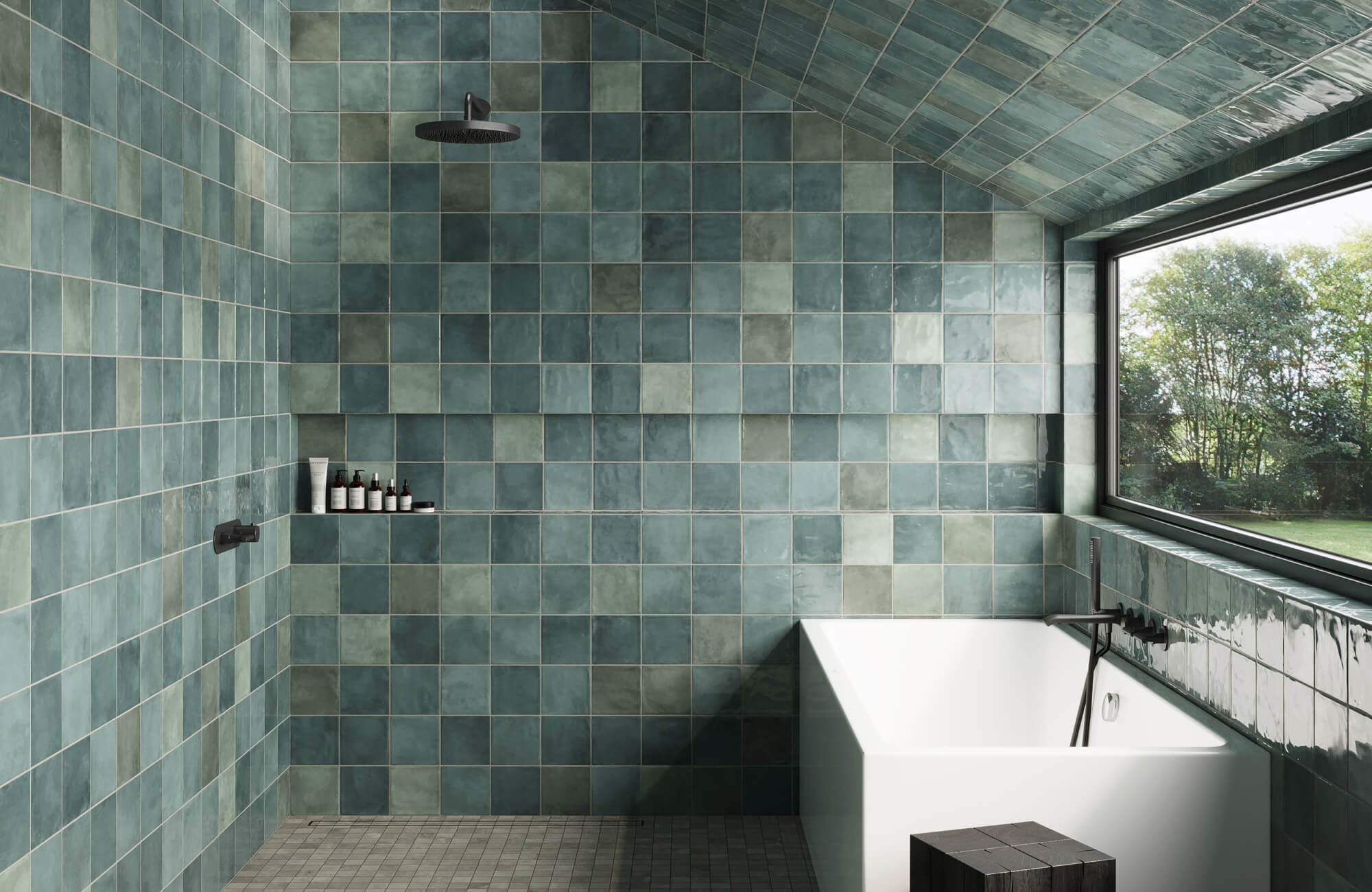 Bathroom with glossy sage green square tiles, soaking tub, sloped ceiling, and large window creating a calm spa-like atmosphere.