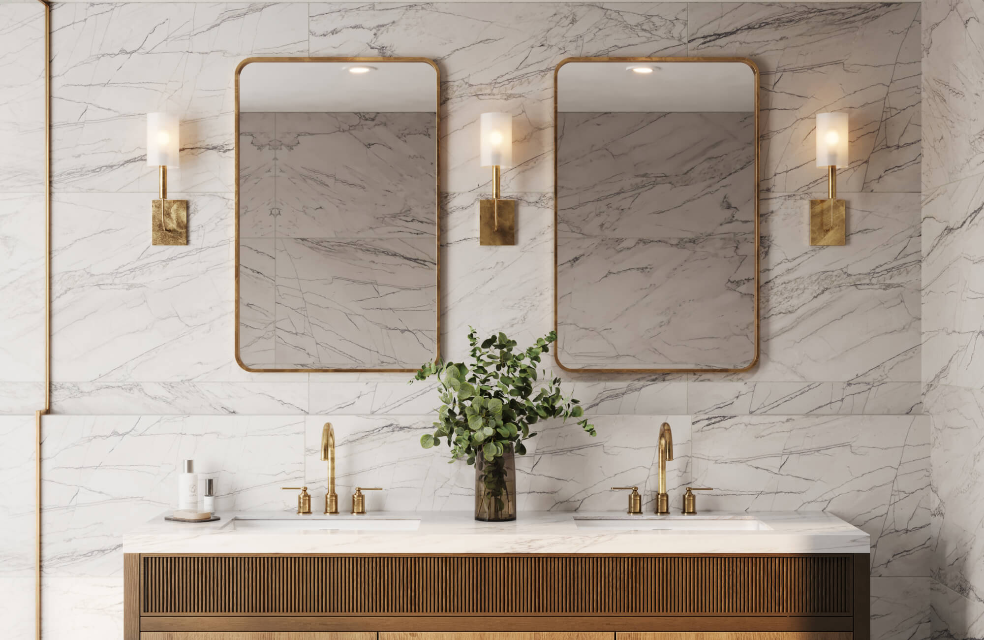 null Marble-clad double vanity with brass sconces, framed mirrors, and fluted wood cabinetry.
