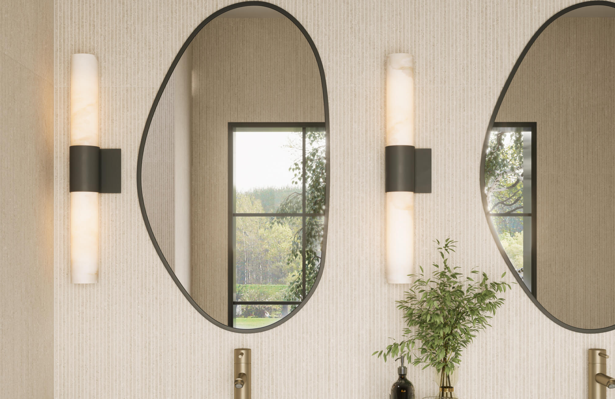 null Modern vertical sconces with alabaster shades flank oval mirrors in a serene, softly lit bathroom.
