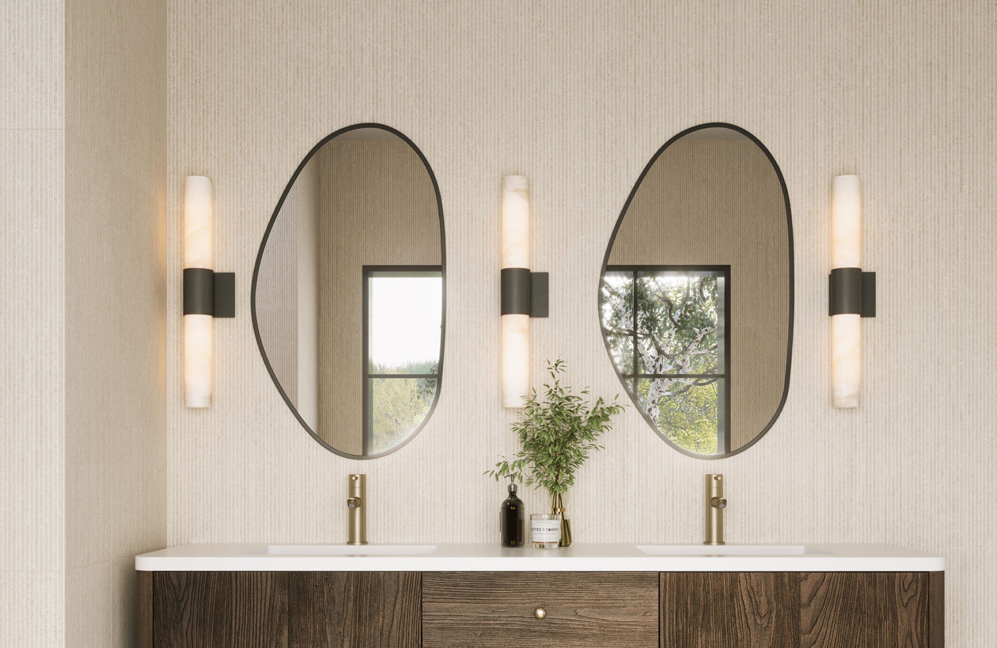 Oval mirrors hung slightly above faucet height, leaving consistent spacing for a sleek and balanced layout.