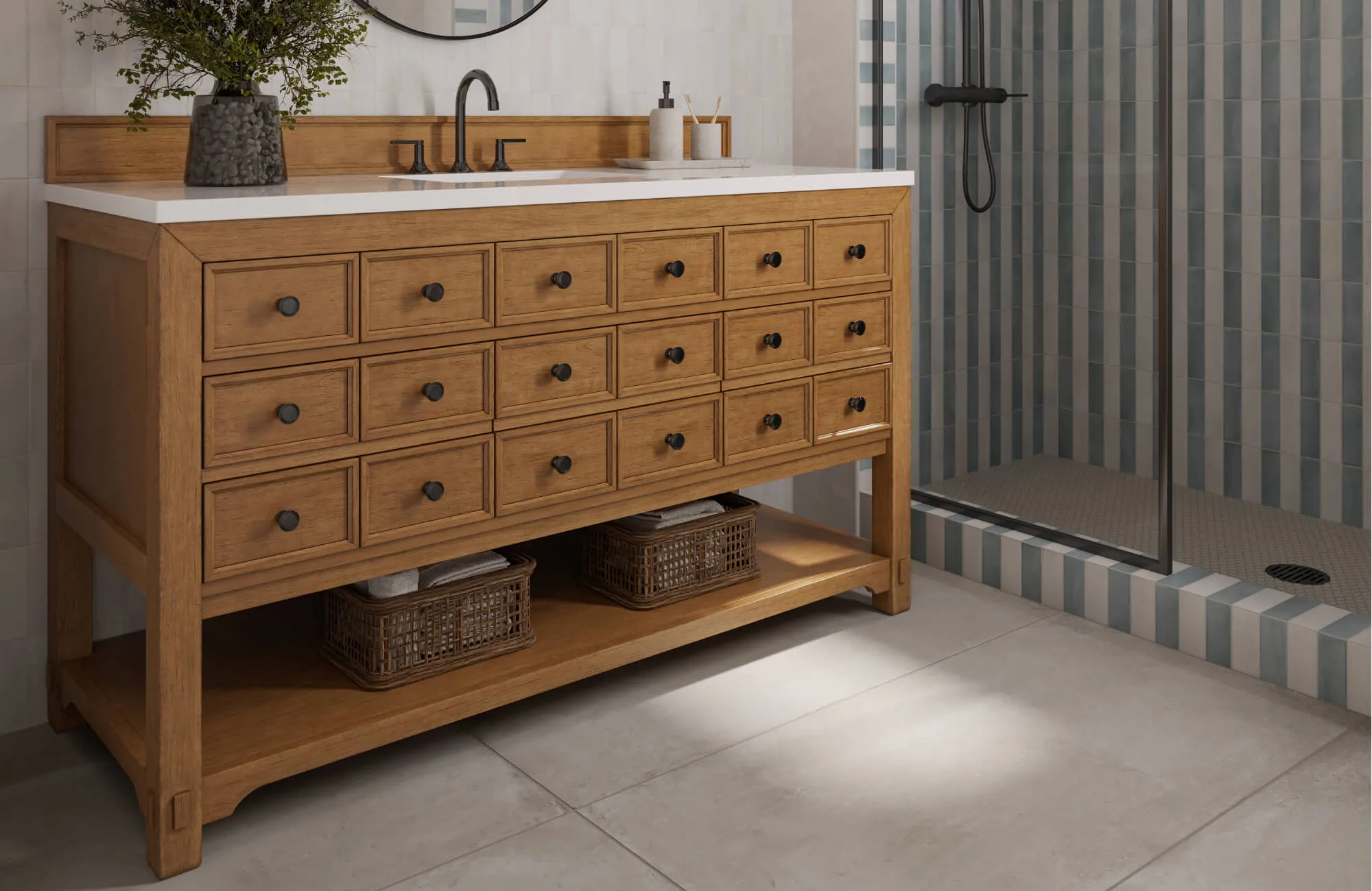 Warm wood vanity with black hardware stands over soft neutral floor tiles, next to striped shower wall tiles.