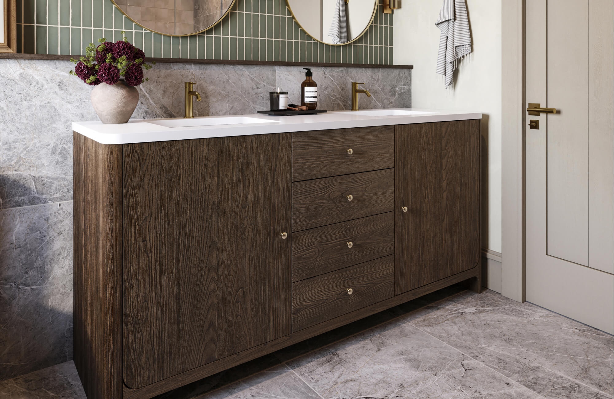 null Modern bathroom with a dark wood double vanity, white integrated sinks, brass faucets, marble backsplash, vertical green tile accent, and round mirrors above.