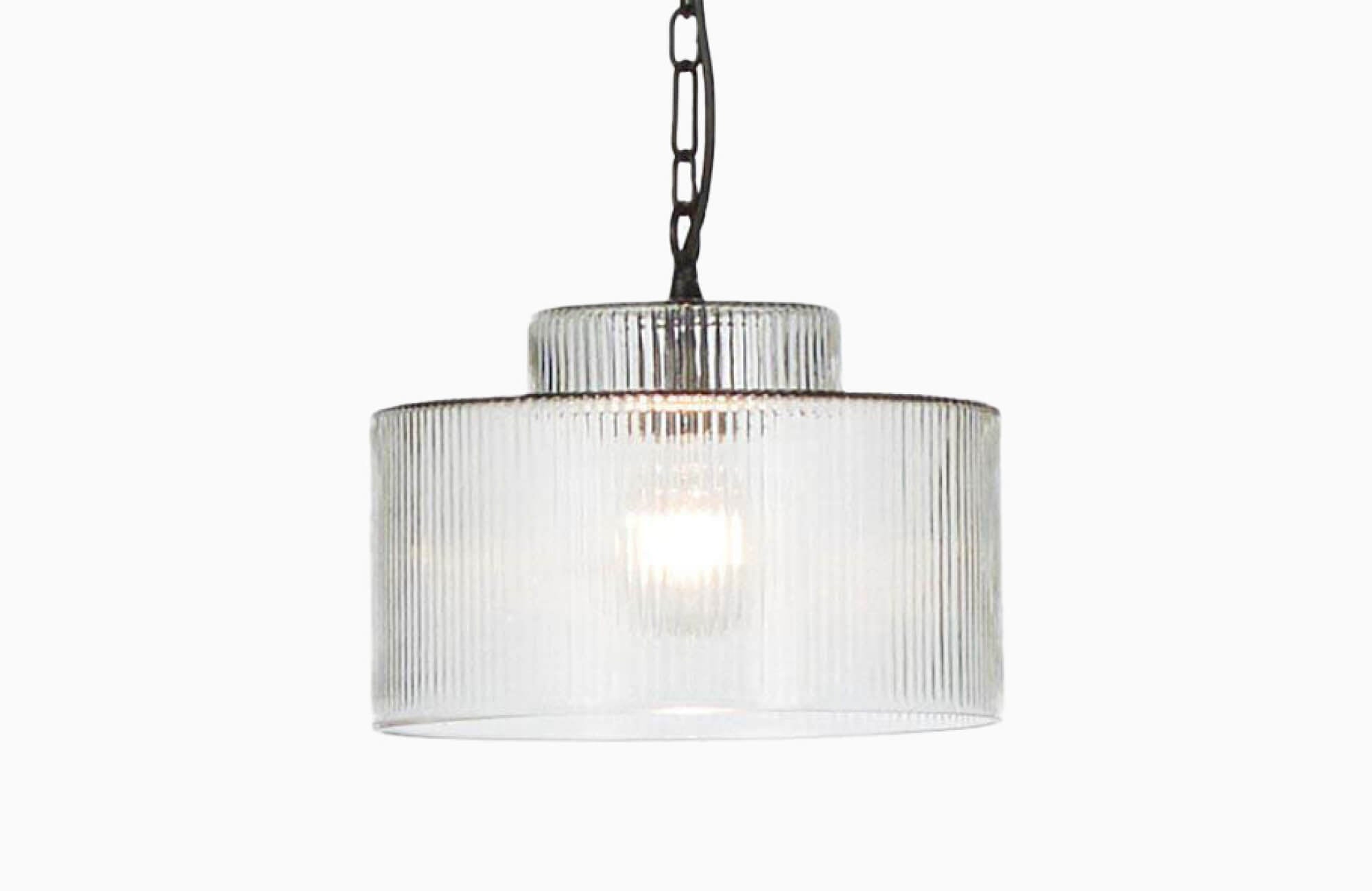 null A sleek ribbed-glass kitchen pendant light with a tiered cylindrical silhouette and black chain detailing offers a modern, softly diffused glow ideal for contemporary kitchen spaces.