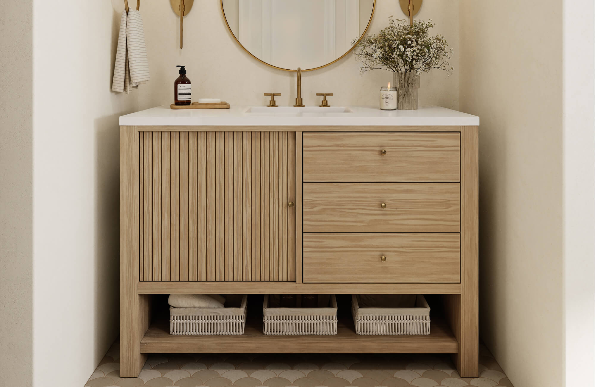 null Light oak vanity with fluted paneling and brass accents pairs beautifully with creamy scalloped floor tiles and a soft neutral wall.
