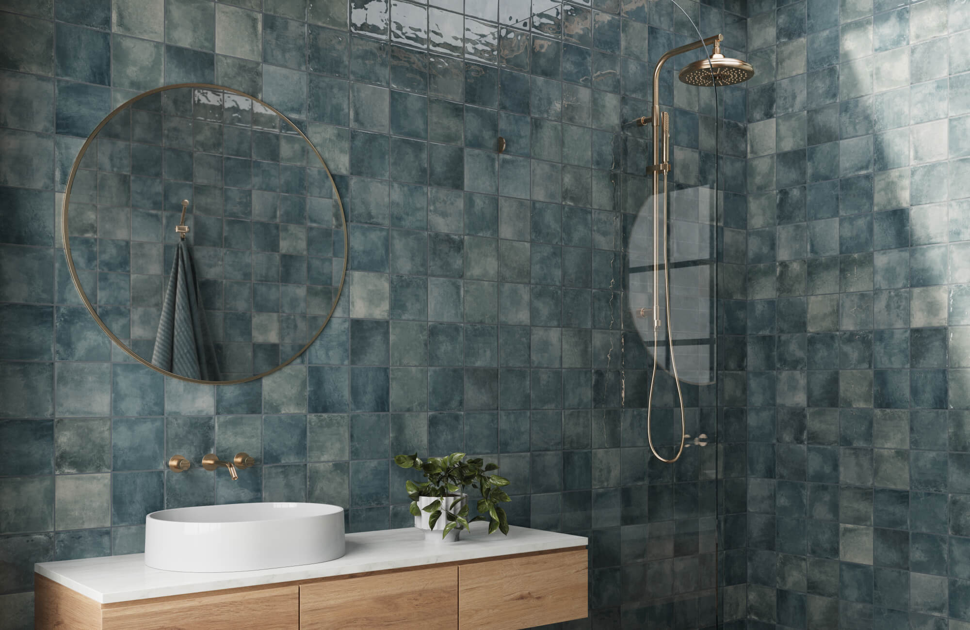 null Dark blue square tiles wrap the bathroom walls, paired with a white vessel sink, wood vanity, and brass shower fixtures for a warm, modern look.