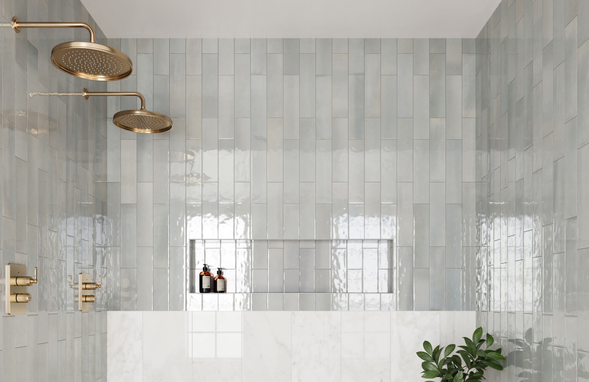 null Pale blue tiles cover the shower walls, reflecting light around brass shower heads and a simple recessed shelf.