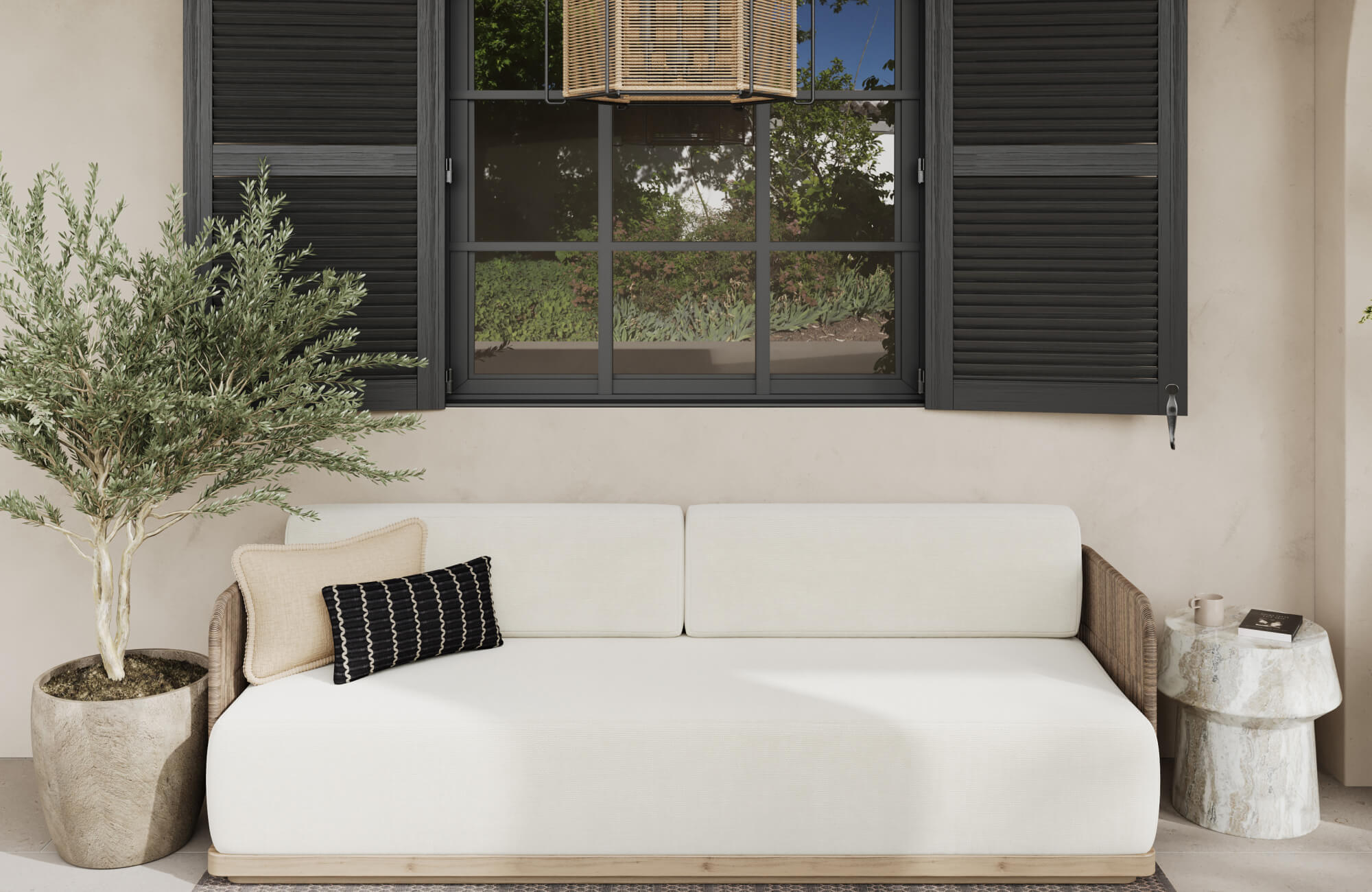 Modern outdoor lounge featuring light upholstered sofa, contrasting throw pillows, marble accent table, and dark window shutters.
