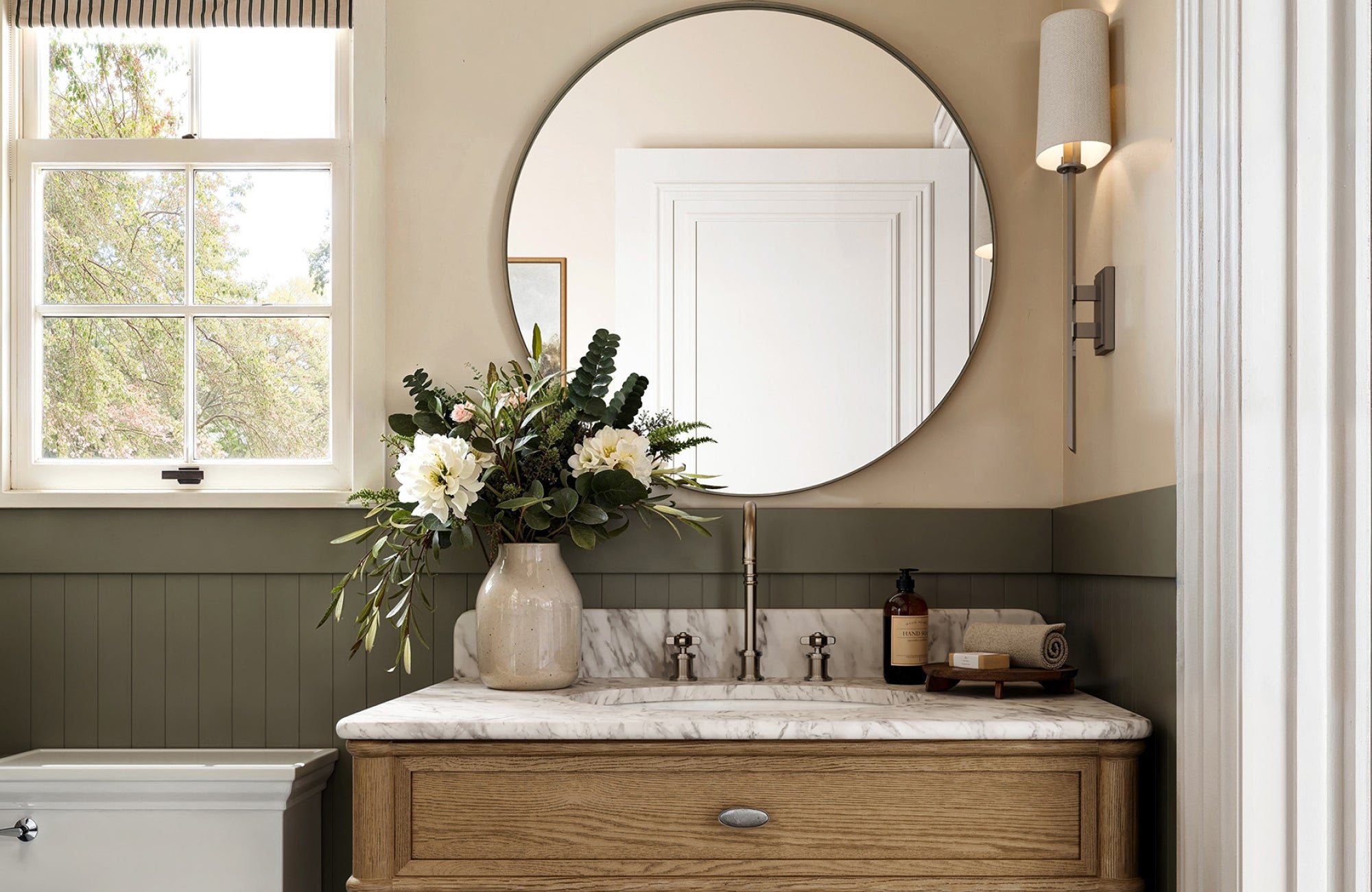 Large round mirror above a 30-inch vanity, demonstrating proportional width and cohesive vanity alignment.