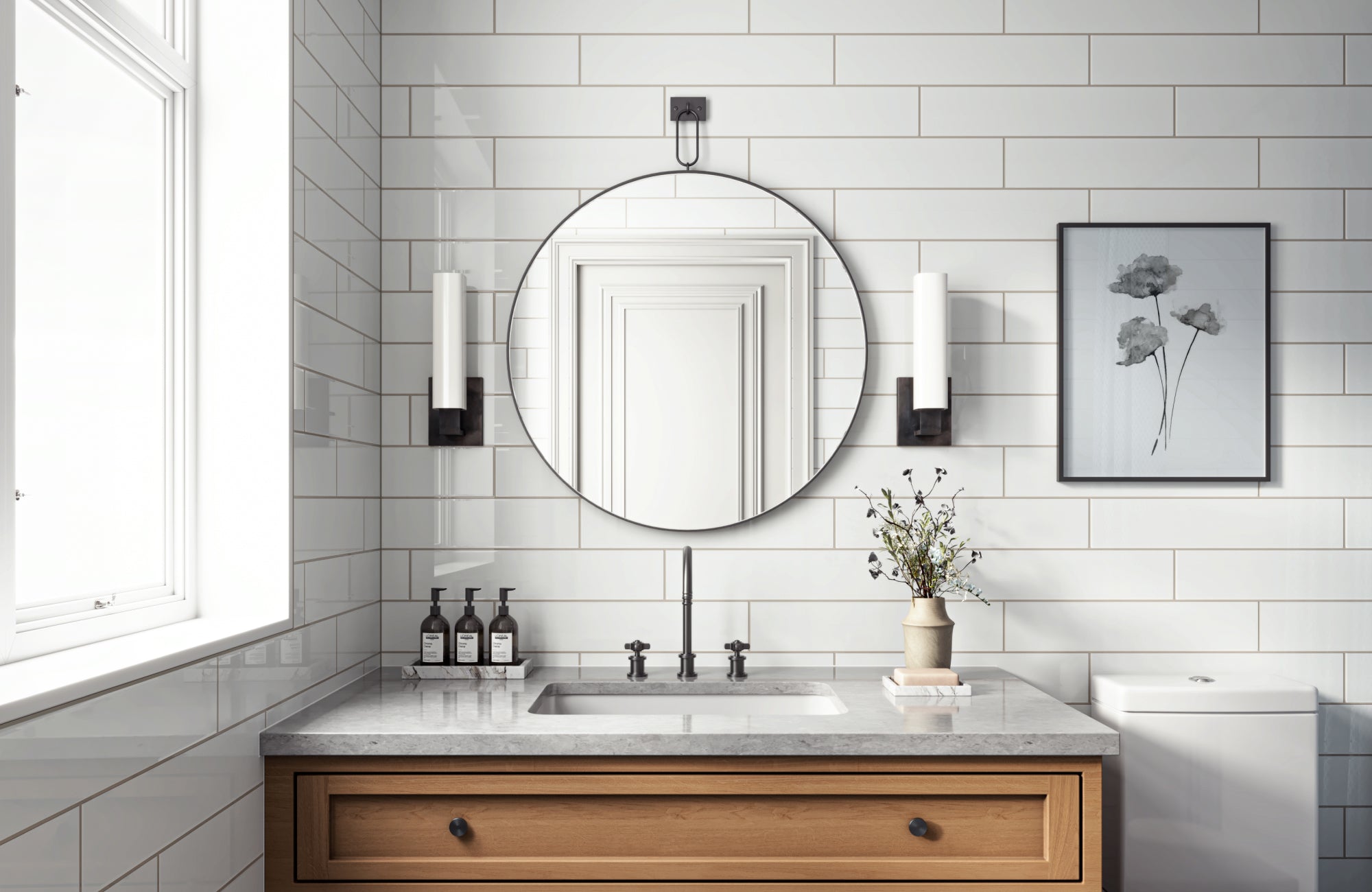 null Round mirror centered over a single vanity, sized for full face visibility and framed by vertical lighting.