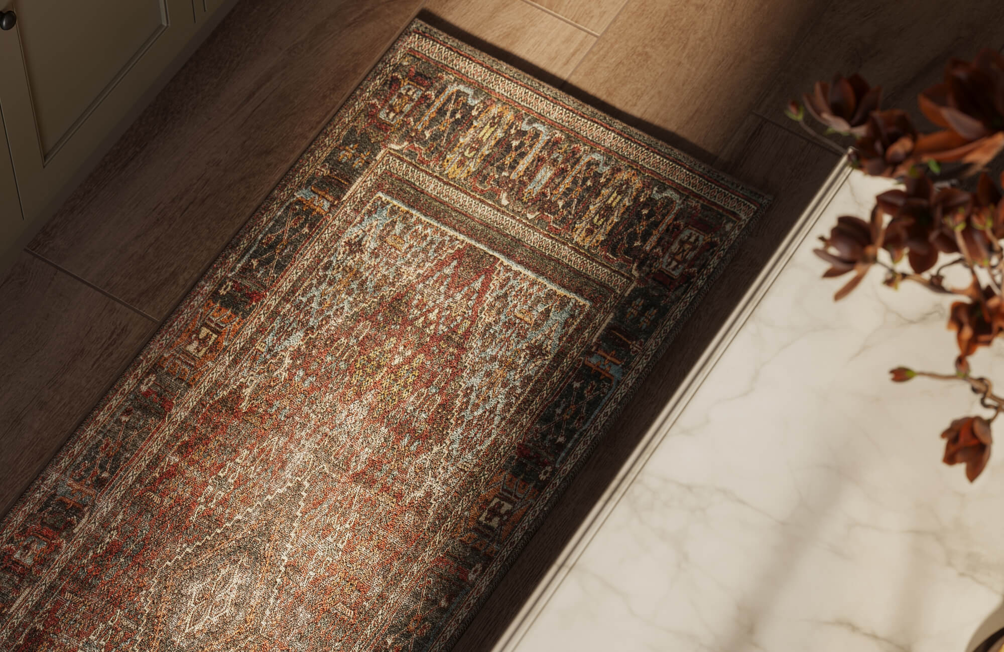 null Vintage-inspired rug with intricate red, charcoal, and muted blue detailing styled beside wood planks and cream marble flooring, highlighting rich texture and pattern.