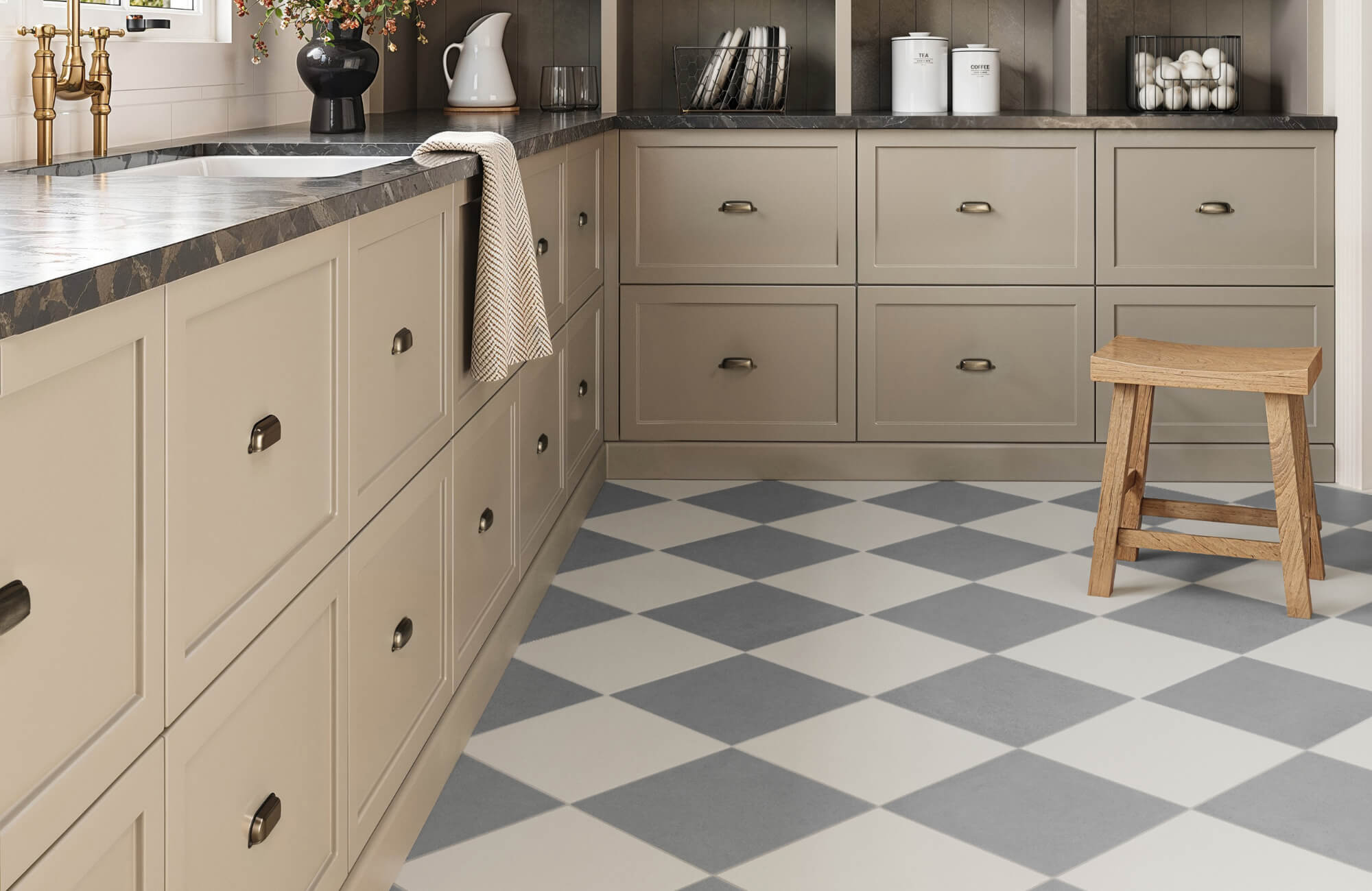 null A warm, neutral-toned kitchen with shaker-style cabinetry, marble countertops, and brass fixtures, where a gray and white checkerboard tile floor adds a soft geometric pattern that brightens and enlivens the classic workspace.