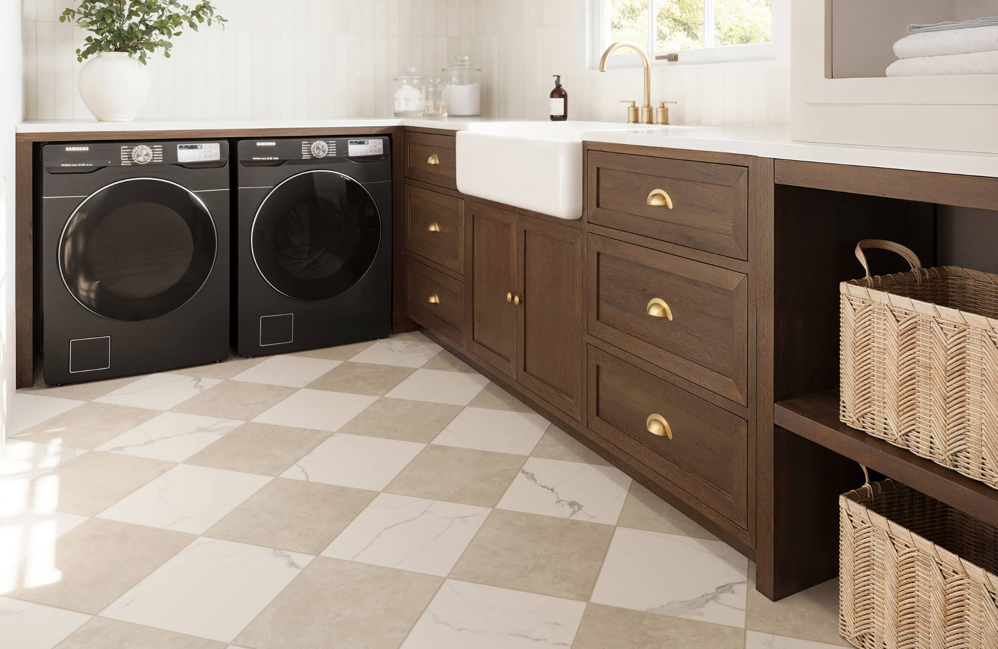 null Bright laundry room featuring beige and white checkerboard tile flooring, dark wood cabinets, black appliances, and woven storage baskets.