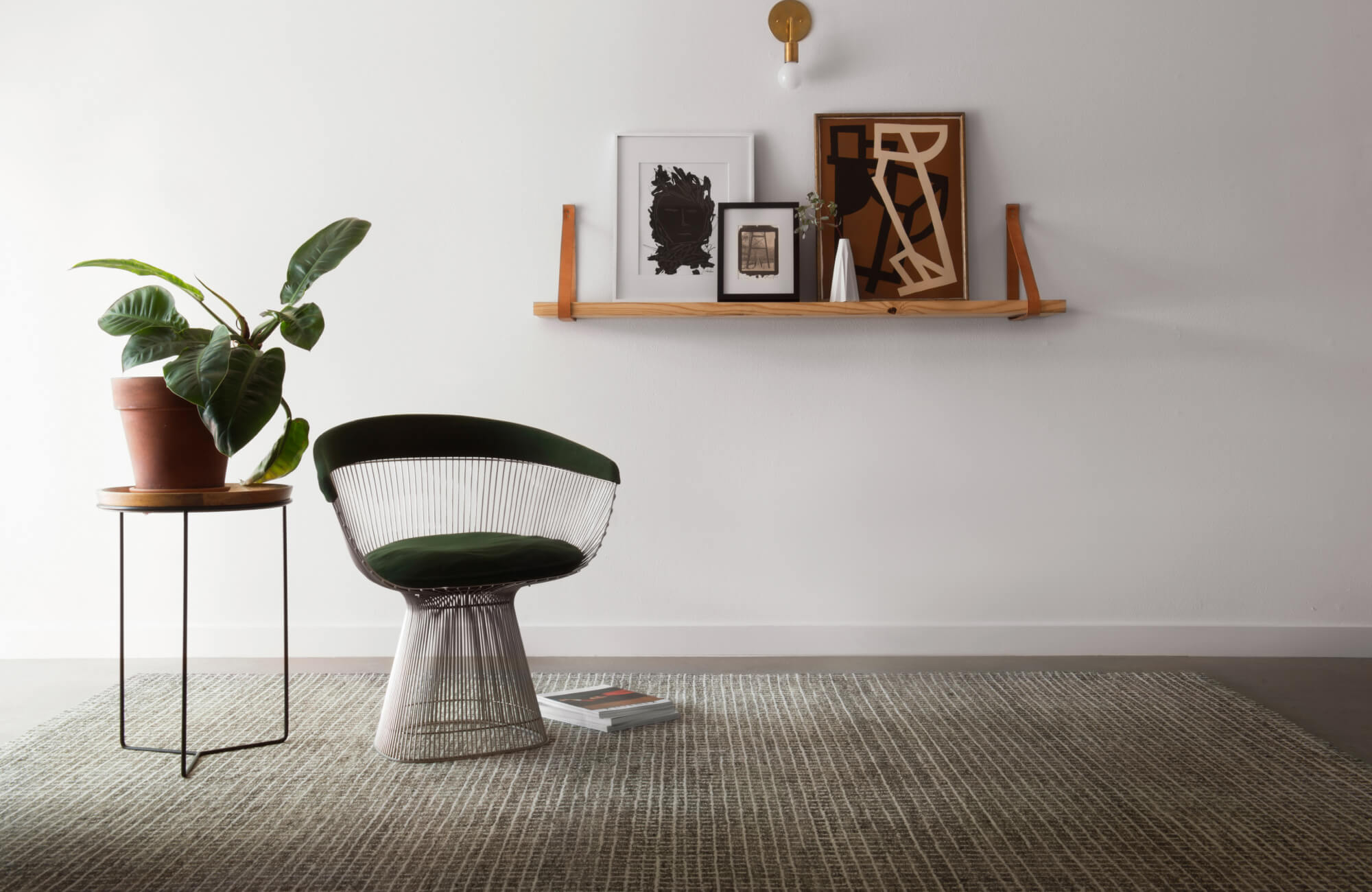 Earth-toned area rug with a subtle grid pattern, grounding a minimalist space with modern furniture and warm decor accents.