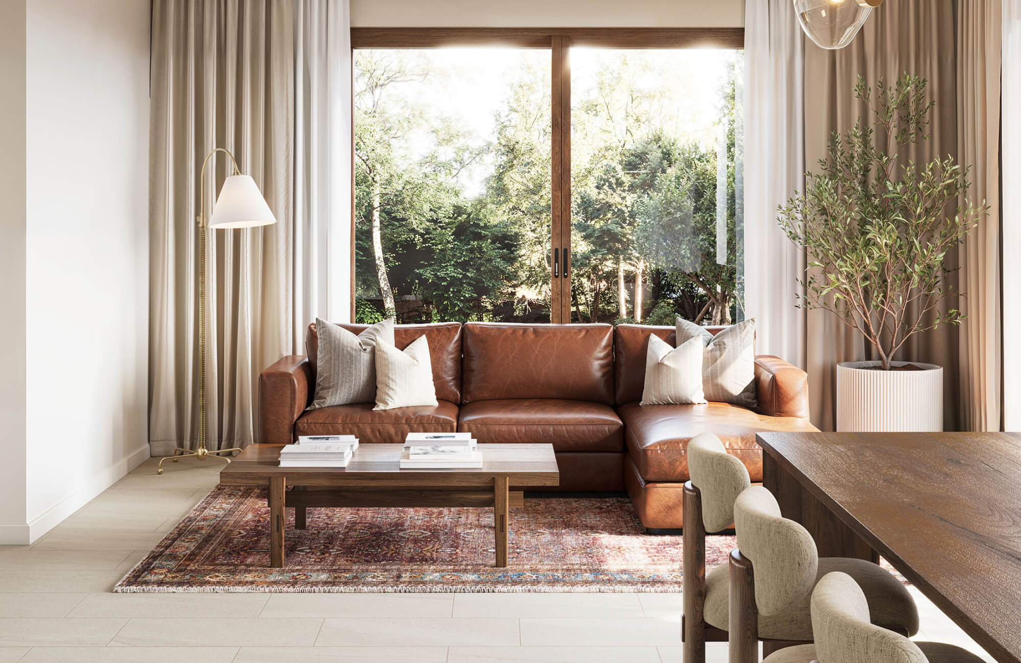 Rust and red patterned rug centered beneath a brown leather couch and wooden coffee table in a modern living room with garden views.