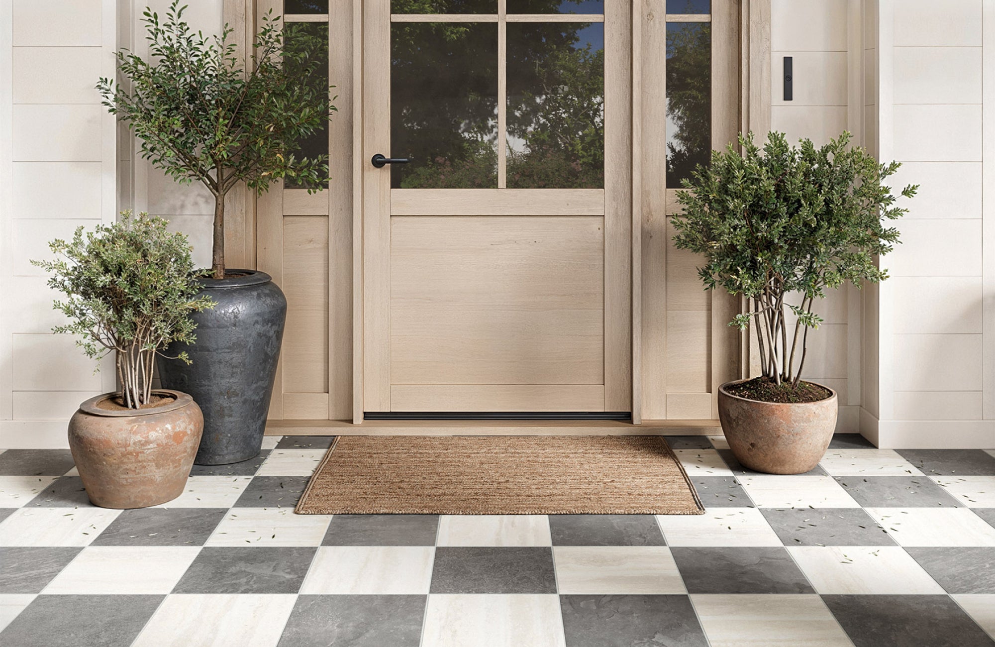 null Small entryway rug placed at the front door, providing coverage for shoes while keeping the surrounding floor visible.
