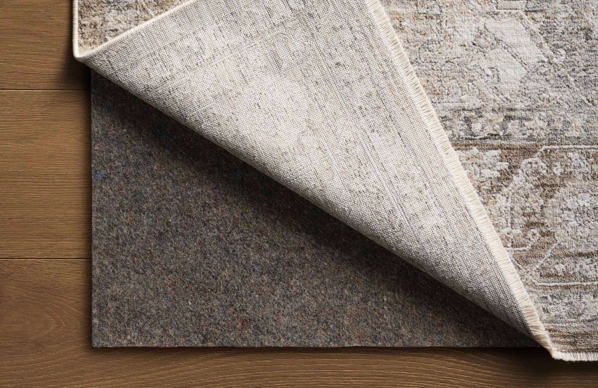 null Entry rug with pad shown beneath, highlighting proper rug sizing and stability to keep it secure in the entry space.