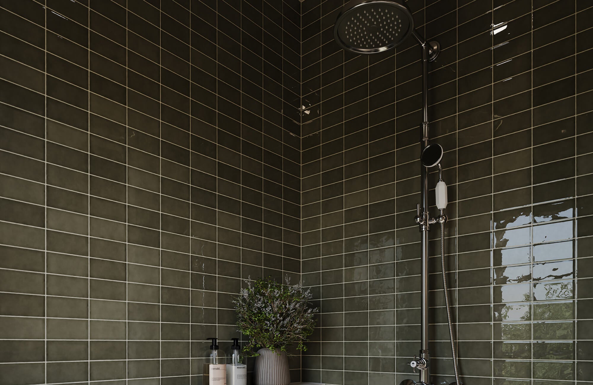 Deep olive green shower tiles with muted variation reduce contrast, helping residue and uneven drying appear less noticeable.