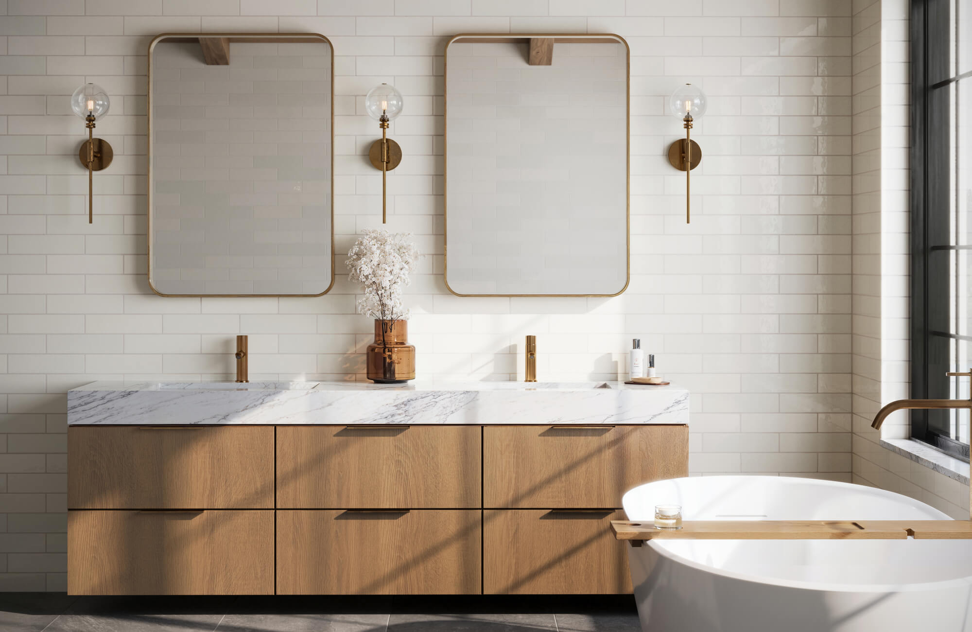 Elegant bathroom design with white subway tiles, a marble-topped oak vanity, gold hardware, and a freestanding tub under soft natural light.