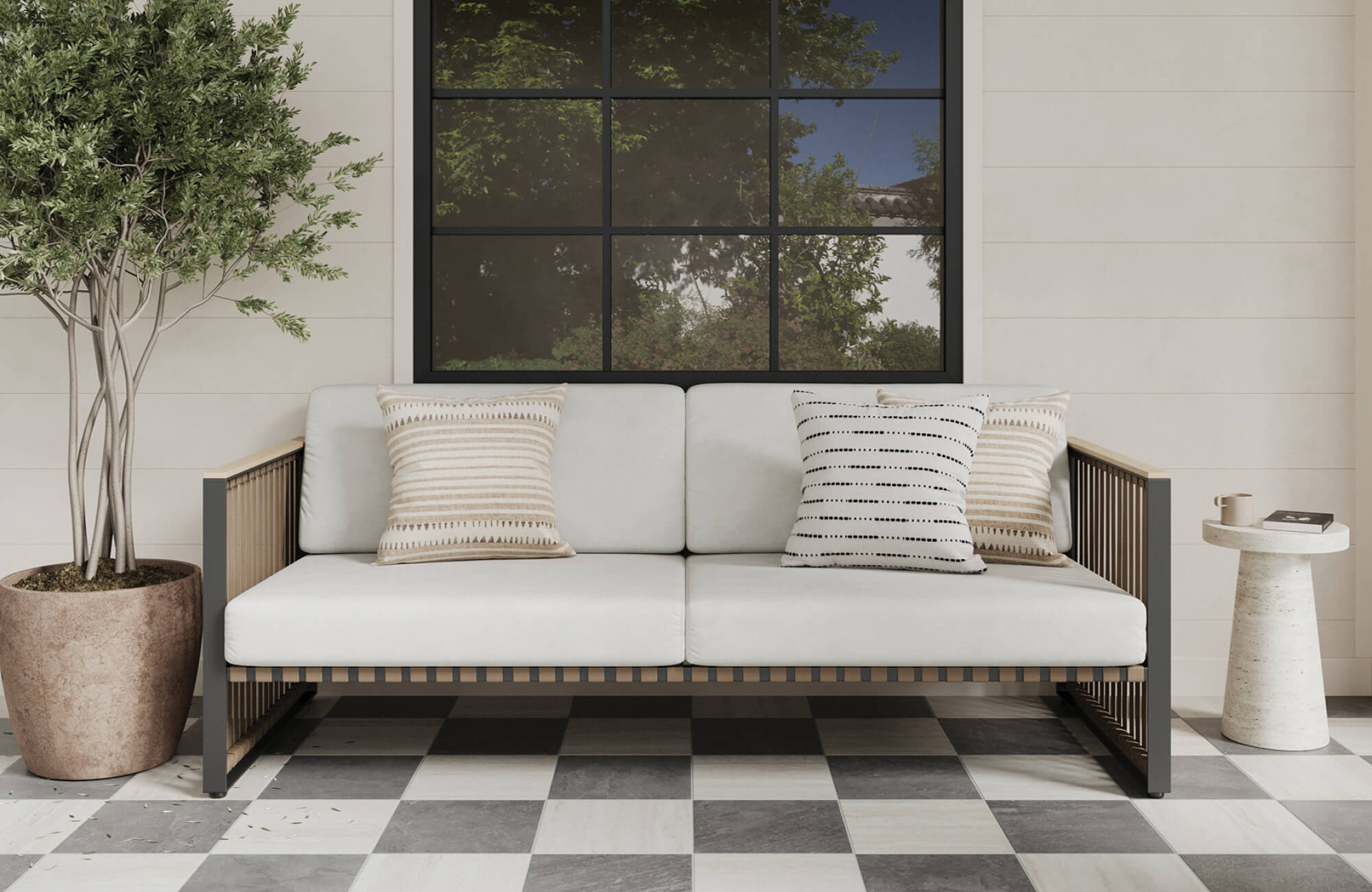 null Covered outdoor sofa with medium square pillows arranged across the seat, showing how standard pillow sizes can soften a sofa while keeping the layout clean and proportional.