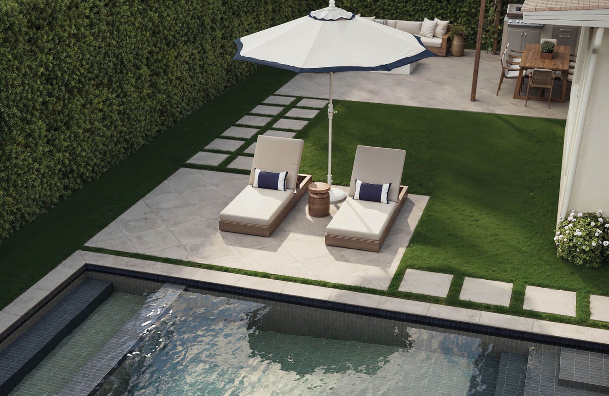 null Poolside lounge area with chaise chairs and compact lumbar pillows, showing how smaller outdoor pillow sizes stay practical and easy to manage near water.