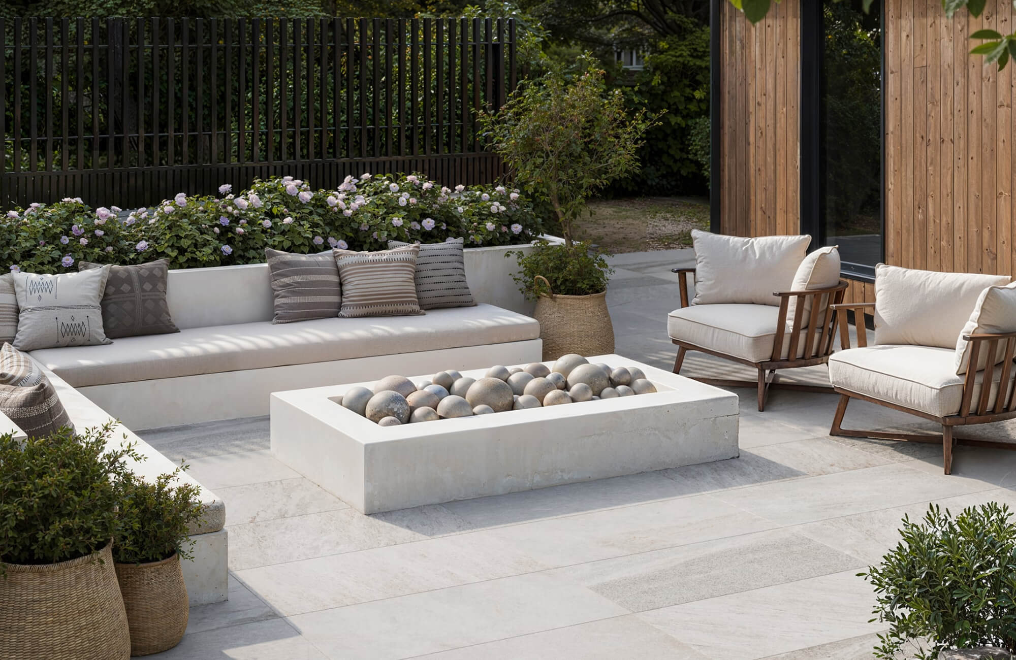 null Spacious outdoor seating area with a built-in bench, lounge chairs, and mixed pillow sizes, showing how larger patios can support fuller pillow arrangements without feeling crowded.