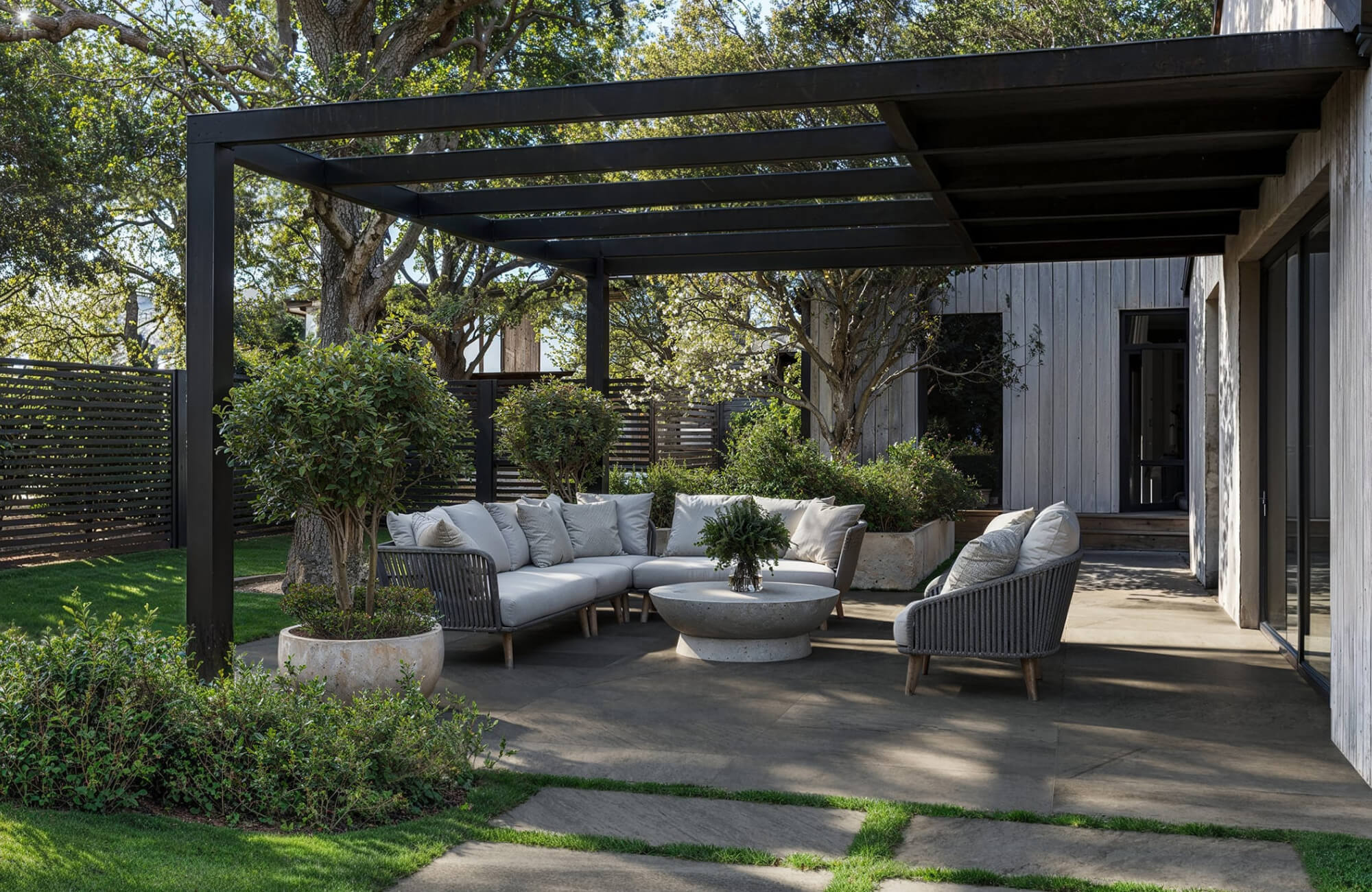 null Modern covered patio with sectional-style seating and consistently sized pillows, illustrating how coordinated pillow dimensions help create a cohesive outdoor seating arrangement.