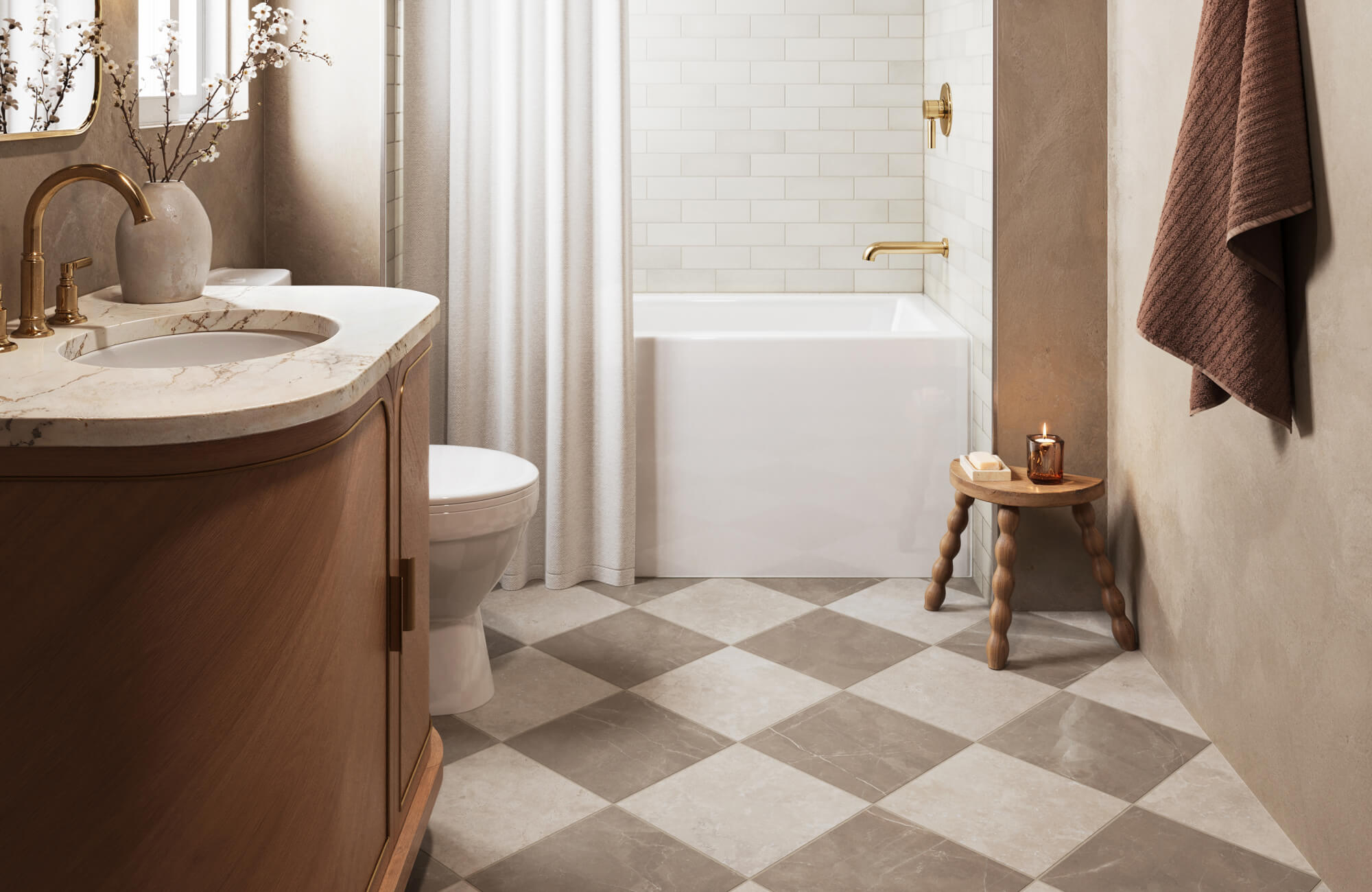 Warm bathroom with taupe checkerboard floor tiles, wood vanity, brass fixtures, and white subway tile tub surround.
