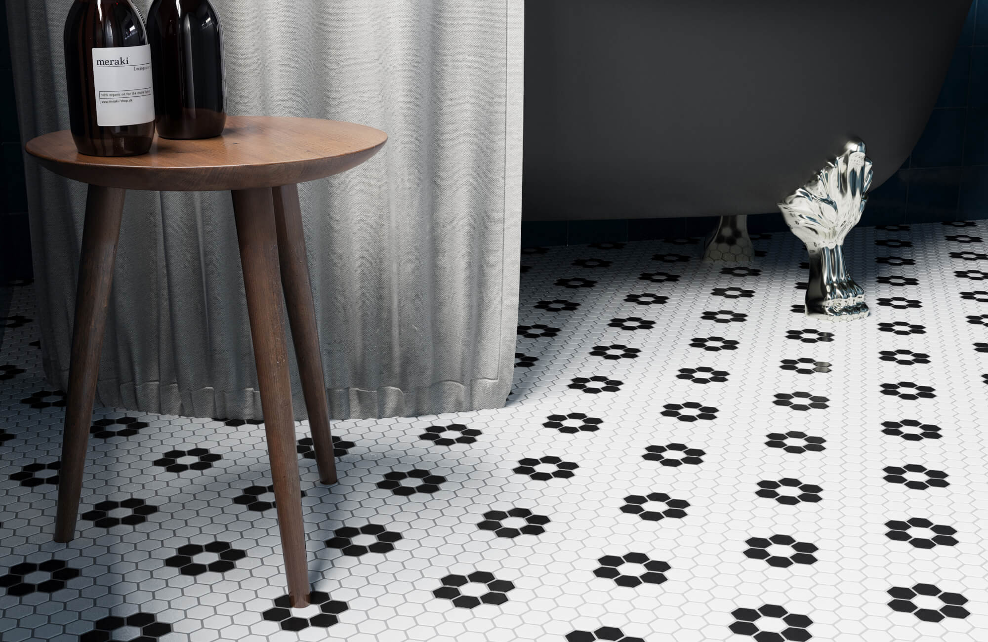 Vintage-style bathroom with black and white hexagon mosaic floor tiles, clawfoot tub, and dark blue wall tile.
