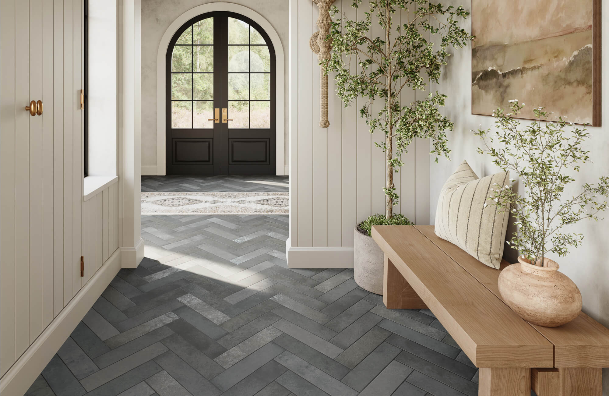 Charcoal-toned herringbone tiles add depth and texture to this serene, light-filled entryway.