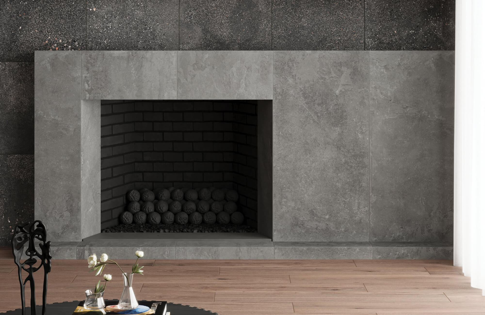 Deep charcoal concrete-look porcelain tiles forming a sleek, modern fireplace surround.