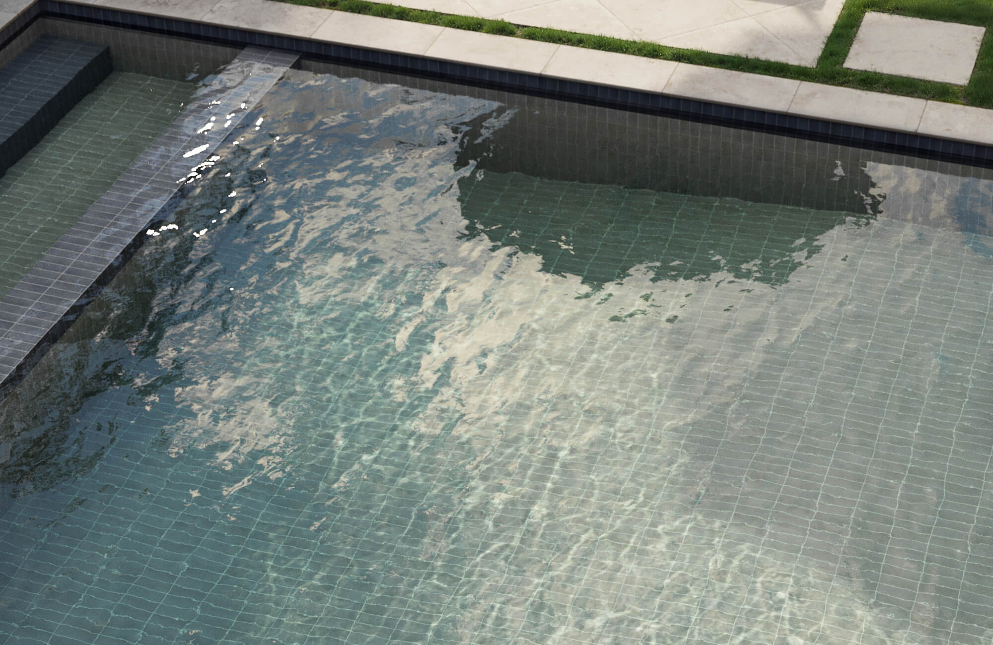 null Modern swimming pool featuring muted green grid-pattern tiles, bordered by dark trim and crisp concrete pavers with grass inlays.
