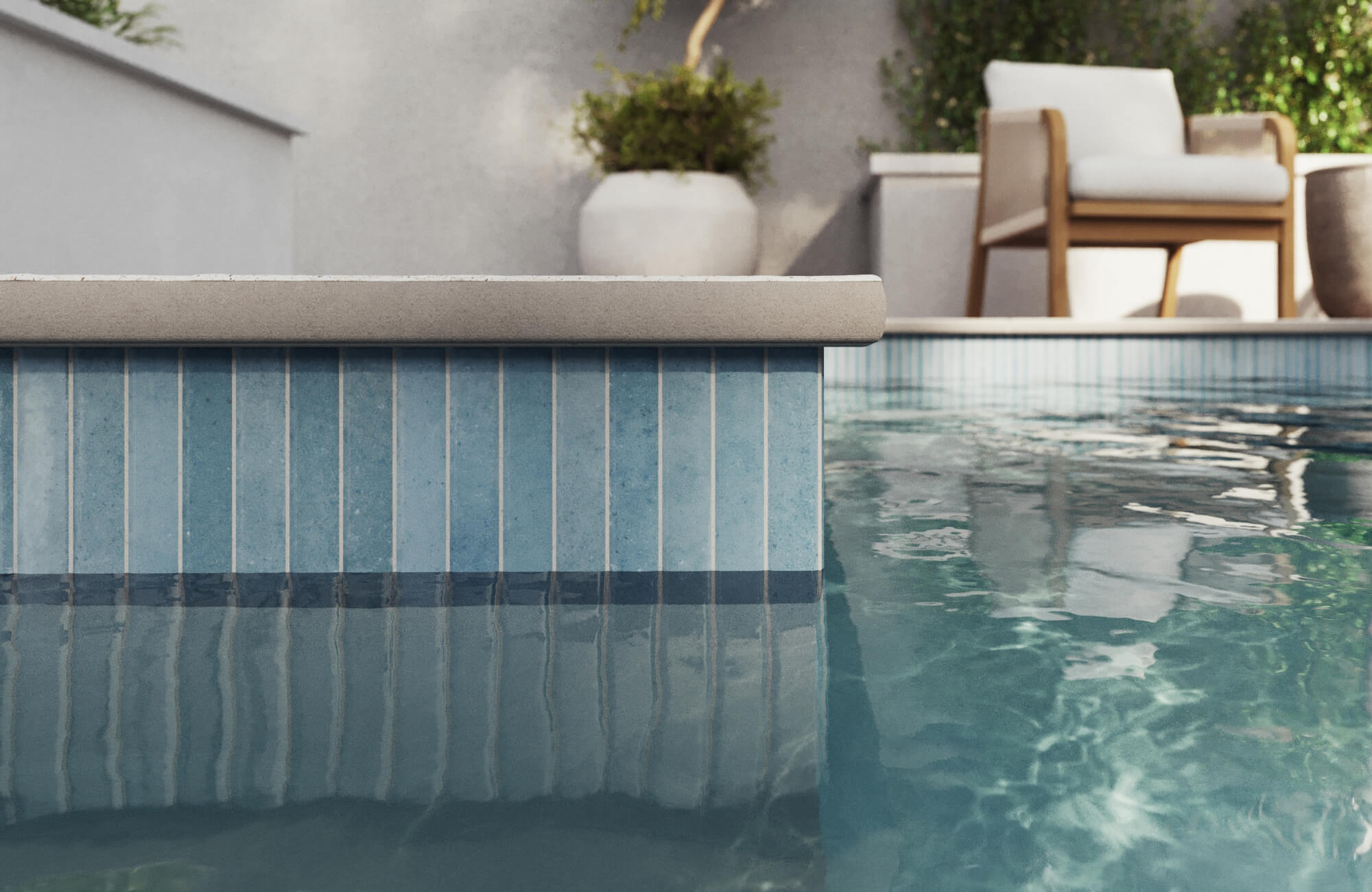 null Serene swimming pool lined with vertical blue tiles and deep navy trim, set in a cozy patio with modern outdoor seating.