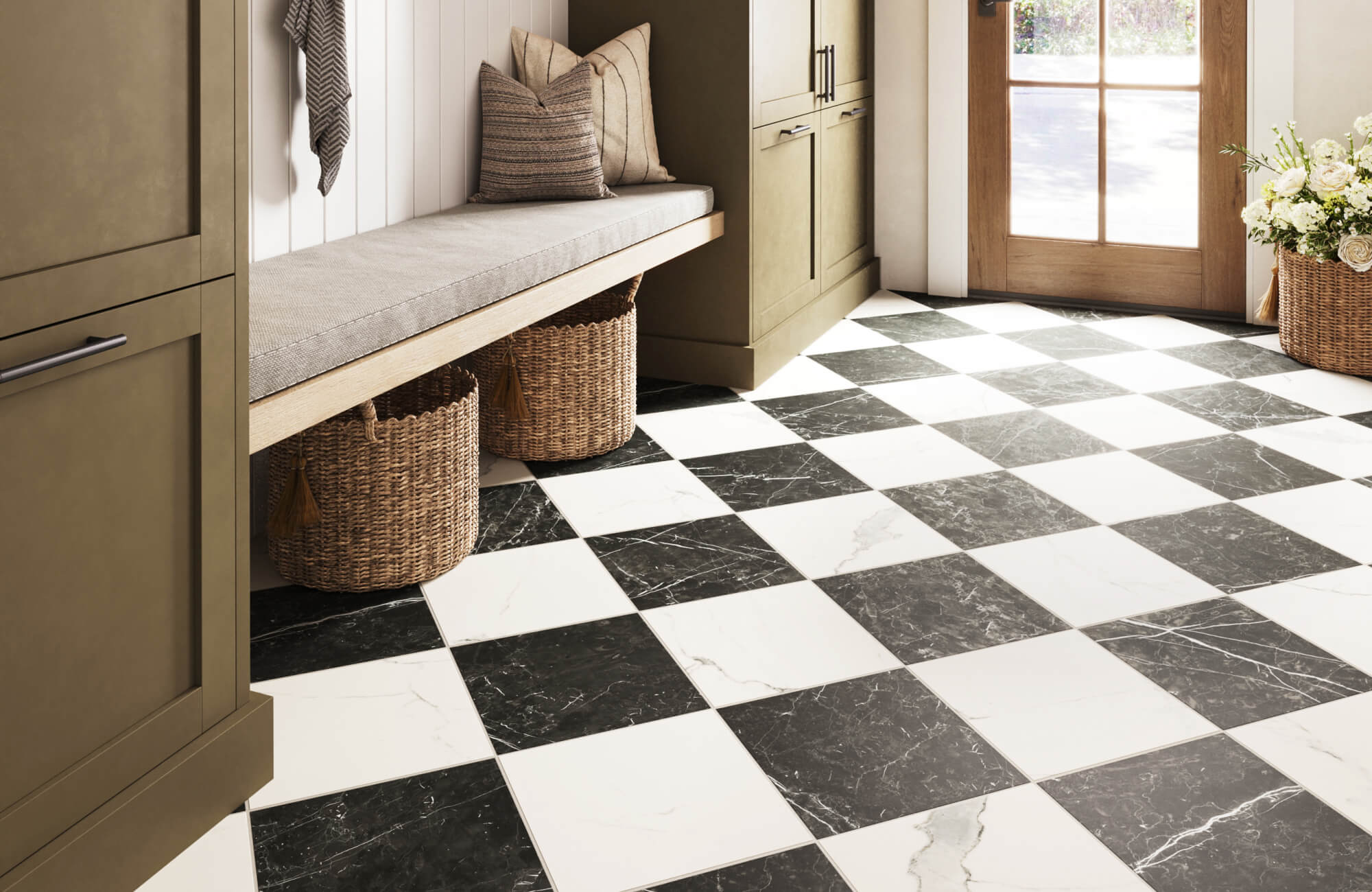 Stylish entryway with a black and white checkerboard floor, built-in bench seating, olive green cabinetry, woven baskets, and natural wood accents.