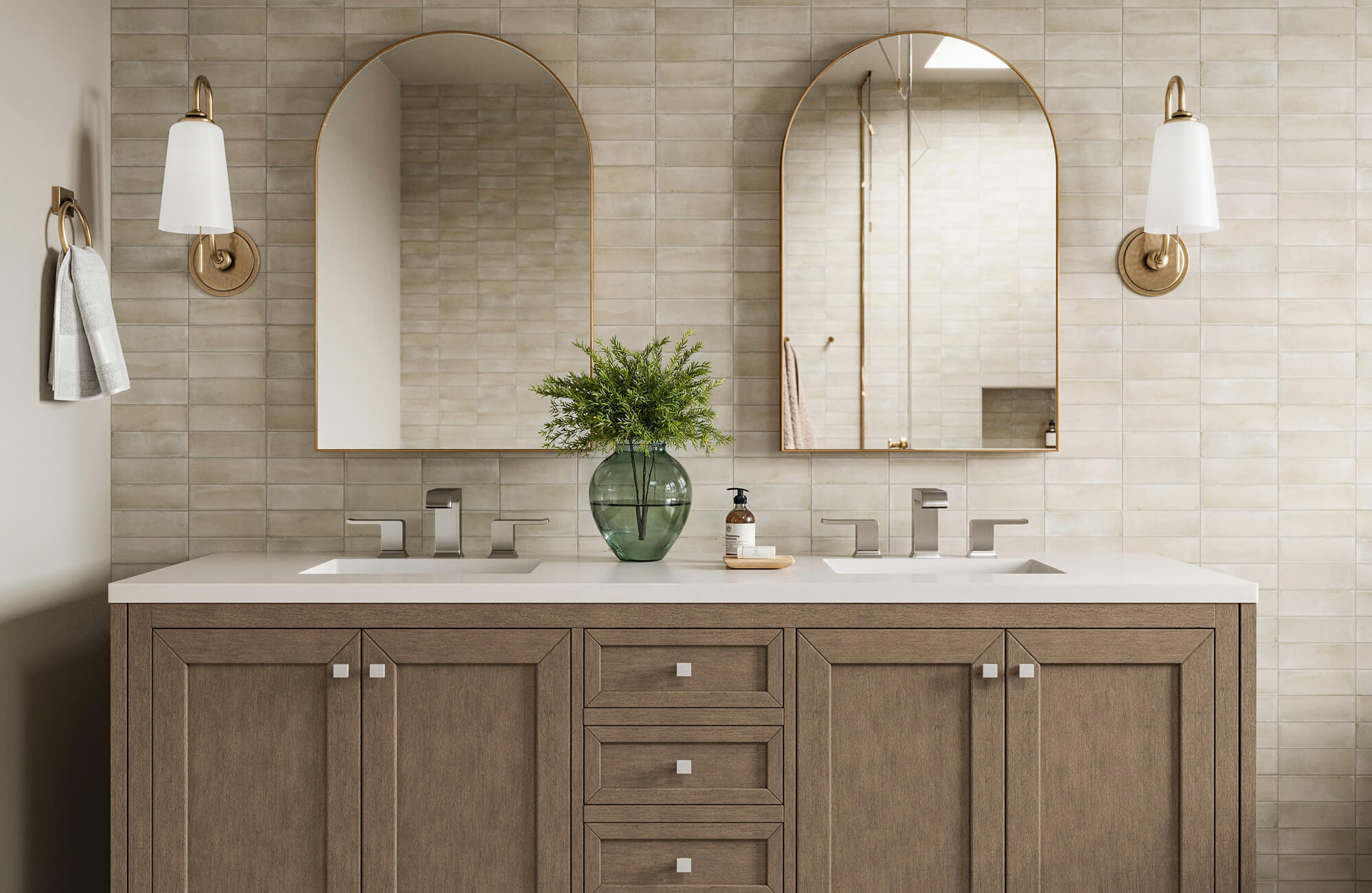 null Elegant bathroom with matte beige subway tiles, arched brass mirrors, and a warm wood vanity with double sinks and chrome fixtures.