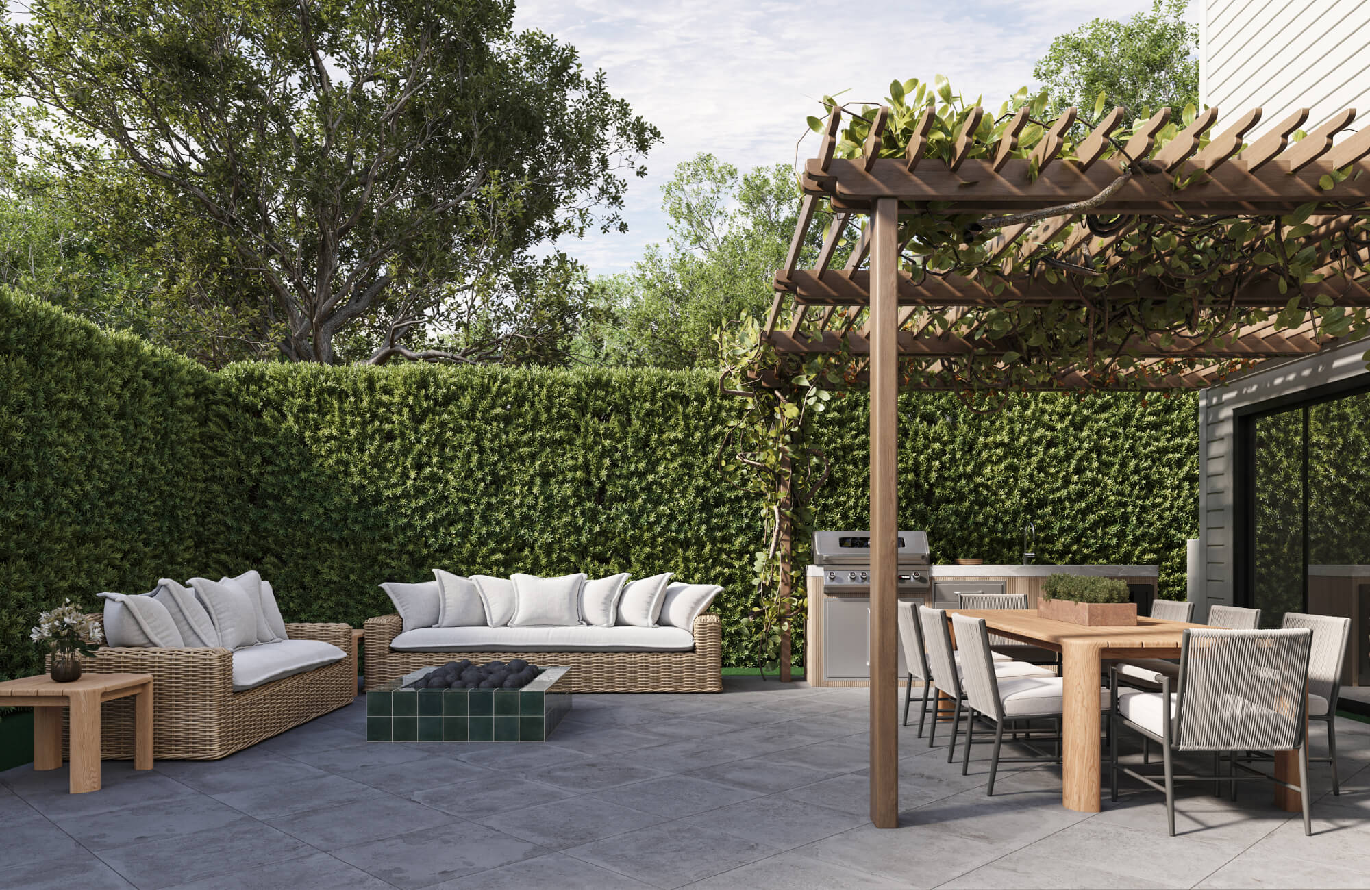 Mixed-material outdoor living space with wood table, metal chairs, and woven seating, demonstrating durability and material considerations