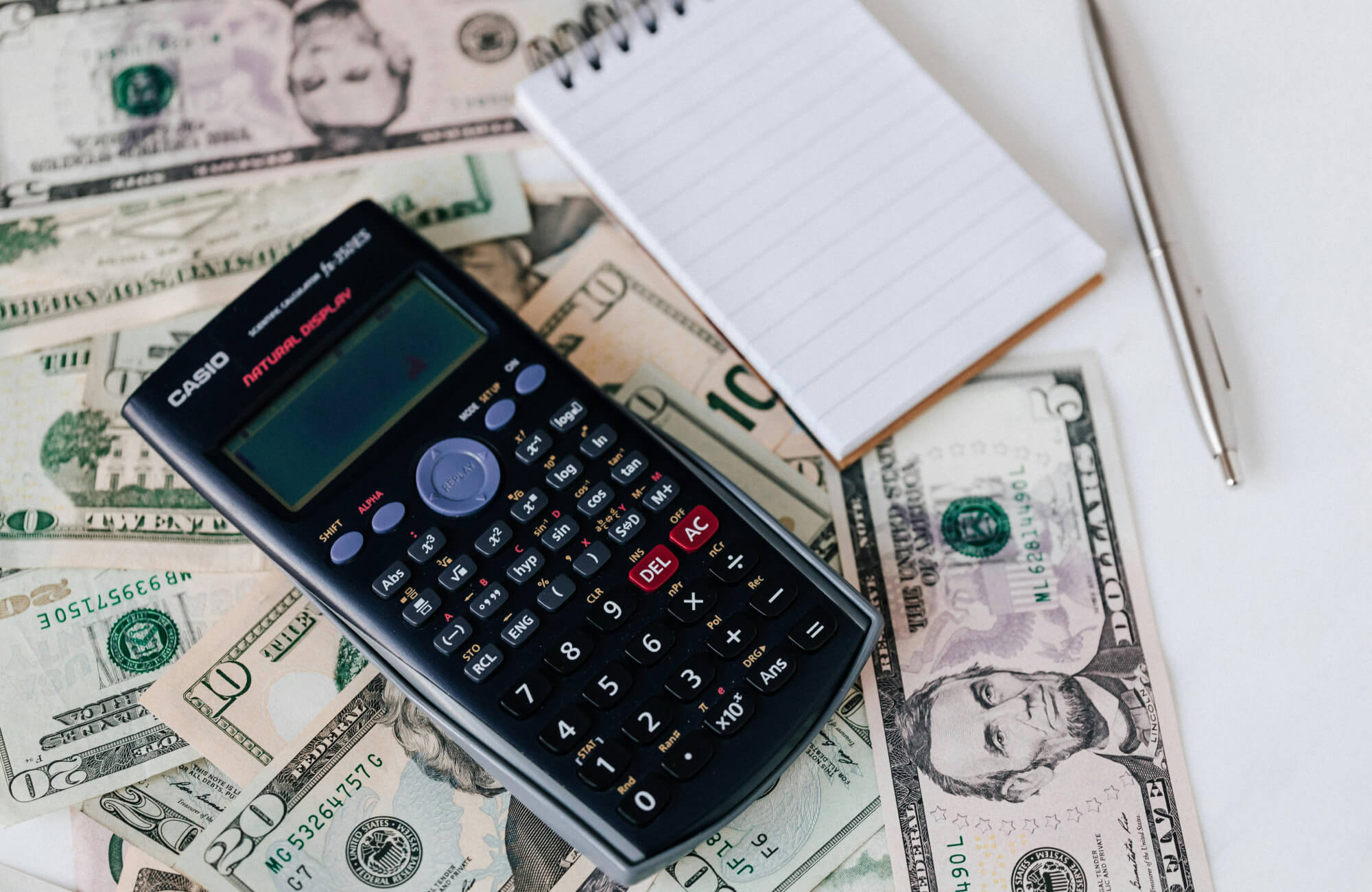 Budget planning concept with calculator and cash, representing cost evaluation and value assessment when buying outdoor furniture