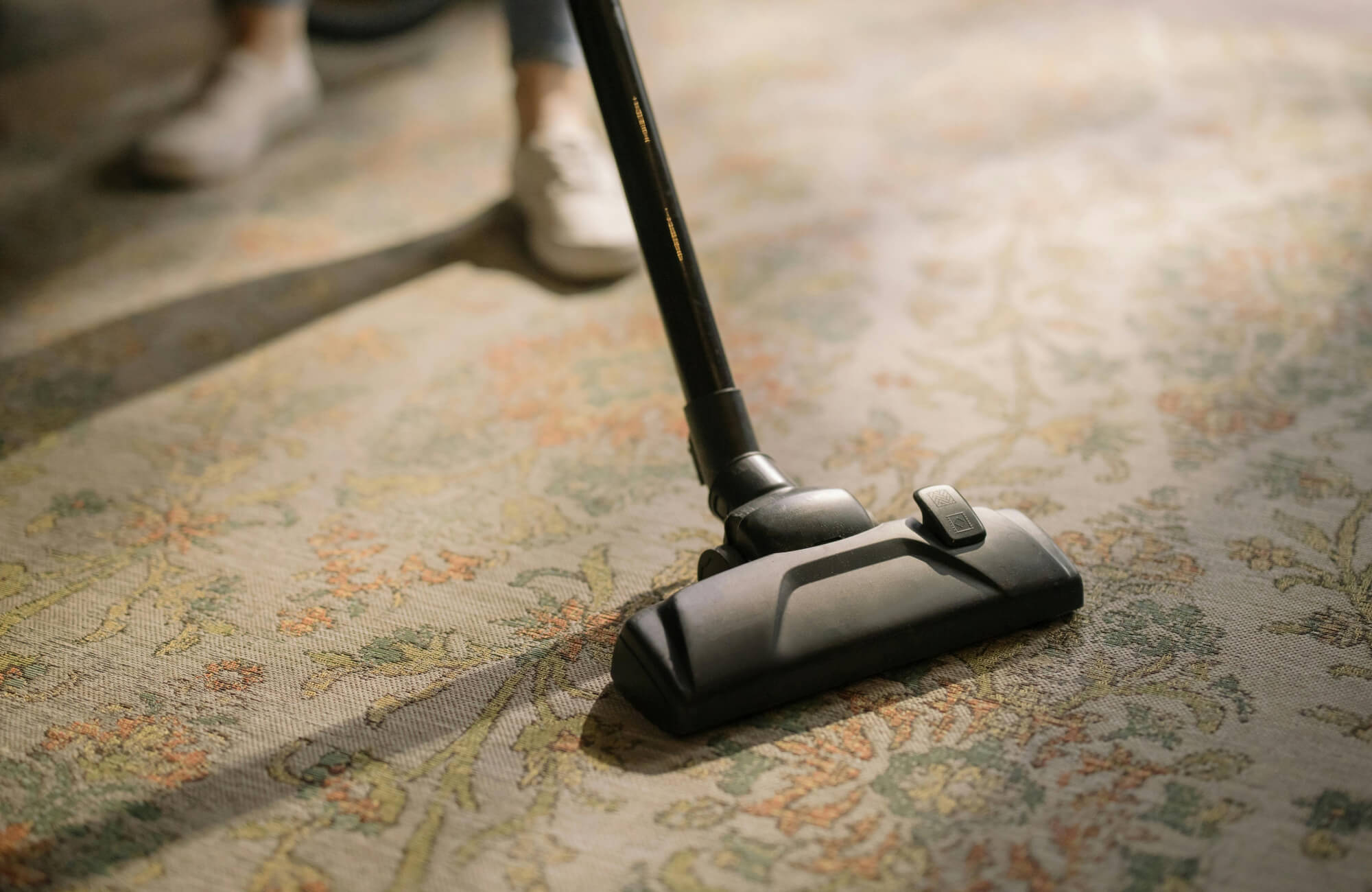 Traditional outdoor rug being vacuumed to highlight easy cleaning, simple upkeep, and long-lasting freshness.