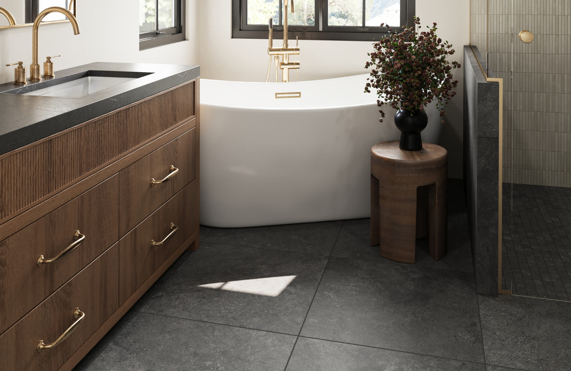 null Modern bathroom with large dark floor tiles, wood vanity, freestanding tub, and glass shower enclosure.