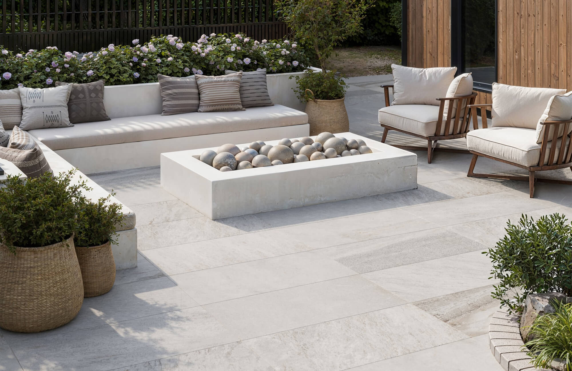null Neutral outdoor tile patio with a fire feature and seating, showcasing durable surfaces that balance comfort and long-term exterior use.